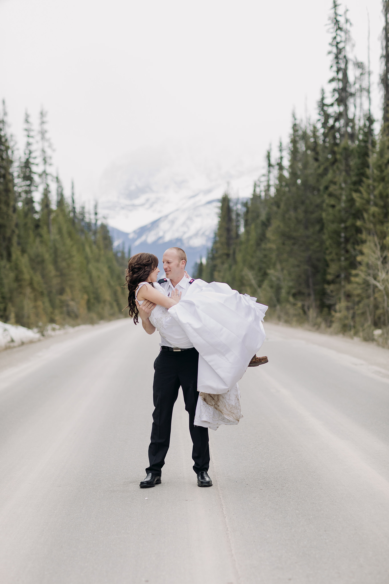 bride swept off her feet in the road to Emerald Lake Lodge for spring mountain elopement