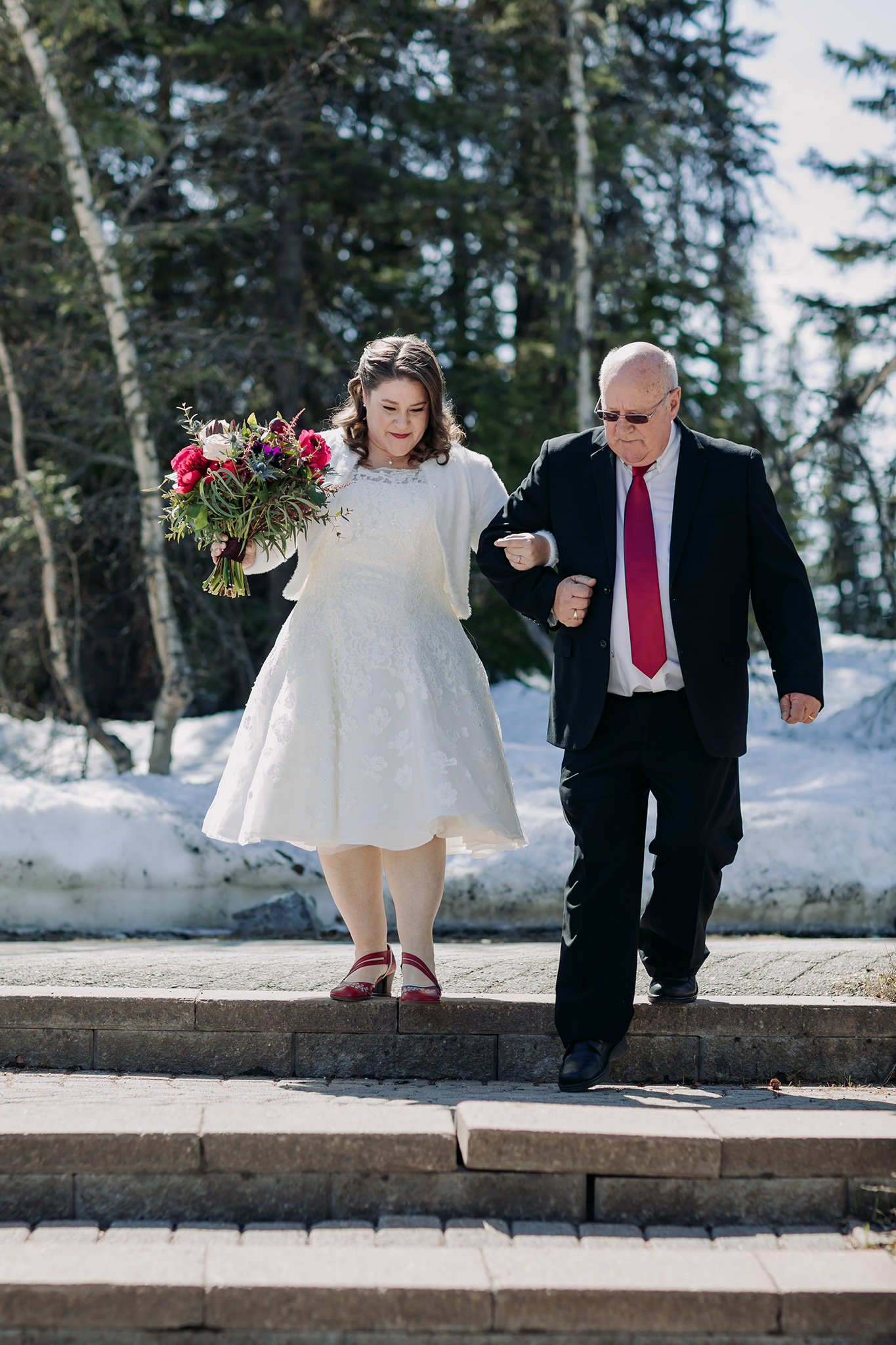 Spring mountain wedding ceremony at the snowy outdoor Viewpoint overlooking Emerald Lake at Emerald Lake Lodge photographed by local mountain intimate wedding & elopement Photographer ENV Photography