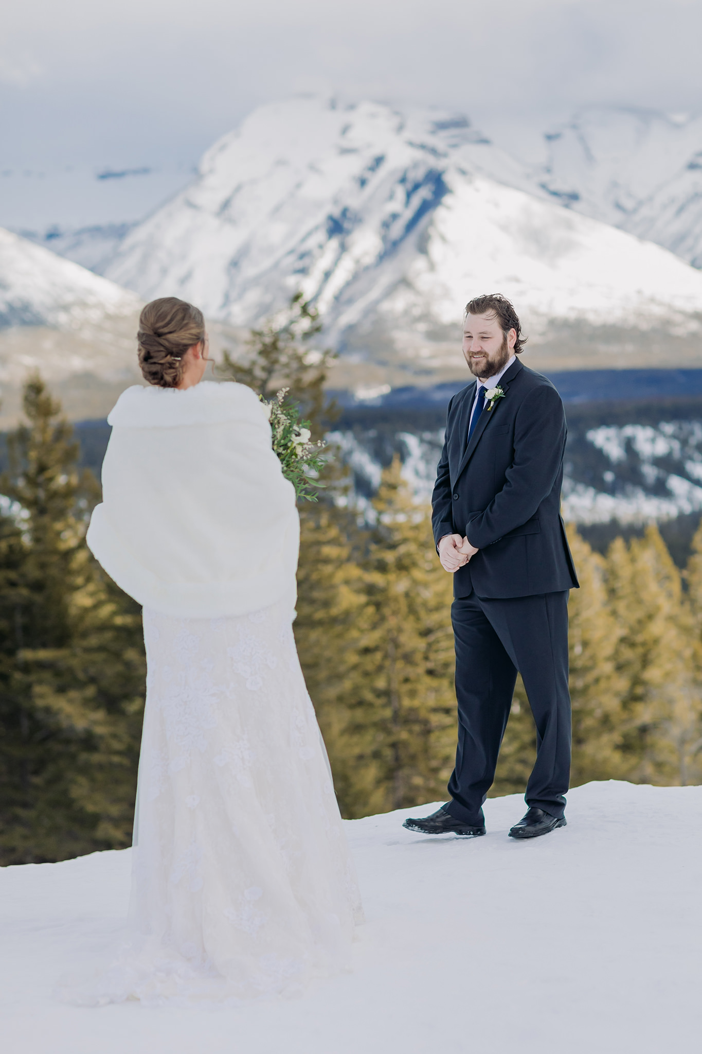 Tunnel Mountain Reservoir bride groom first look in Banff National Park on wedding day. Winter mountain elopement photos