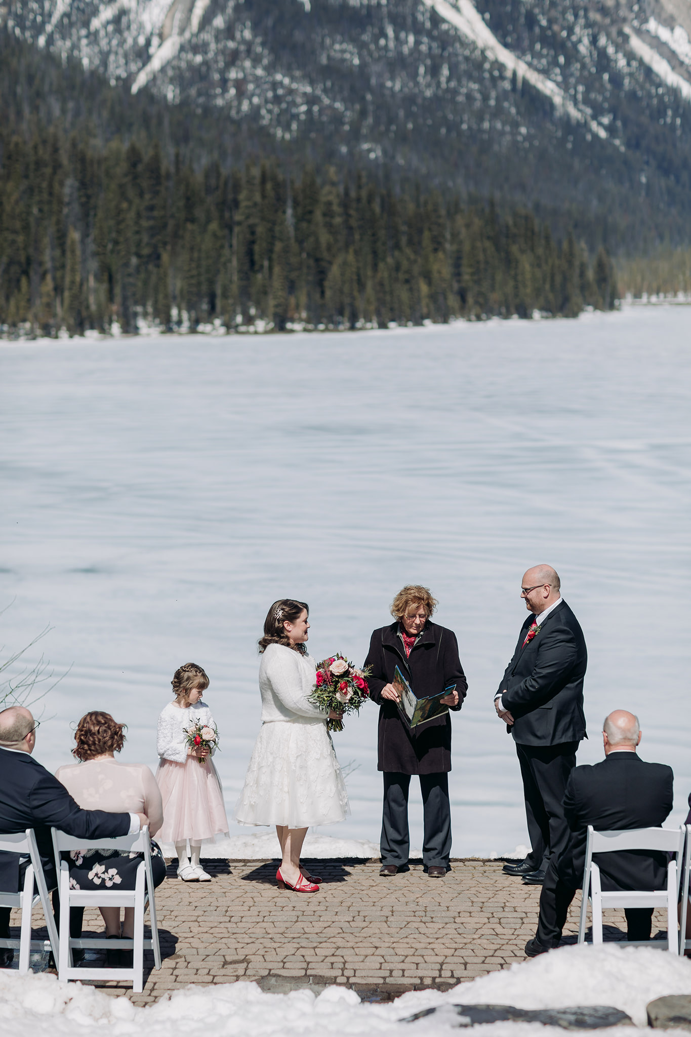 Spring mountain wedding ceremony at the snowy outdoor Viewpoint overlooking Emerald Lake at Emerald Lake Lodge photographed by local mountain intimate wedding & elopement Photographer ENV Photography