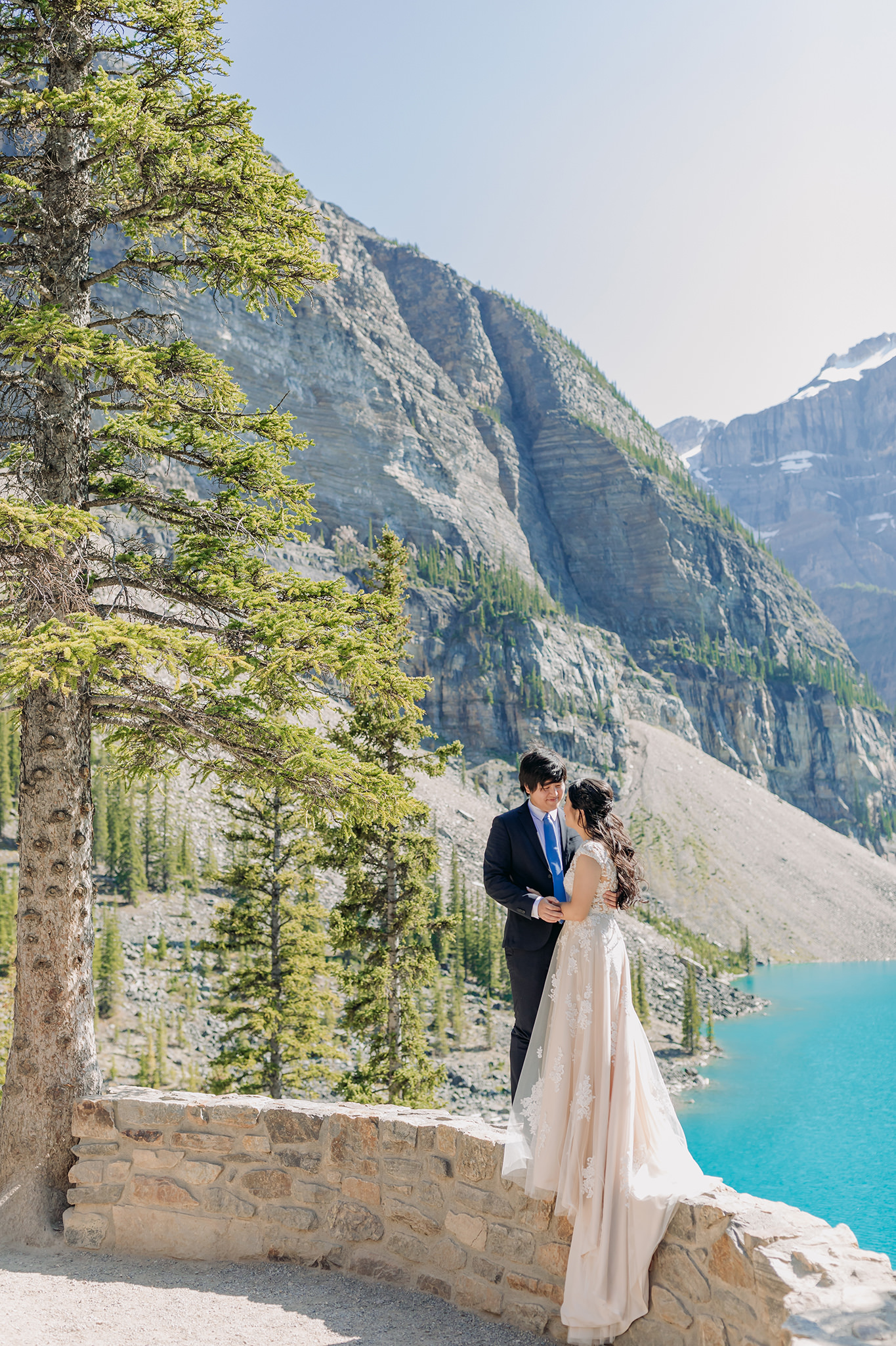Rocky Mountain wedding tour bride groom portraits at Moraine Lake on bright sunny day in Banff National Park photographed by mountain elopement specialist ENV Photography