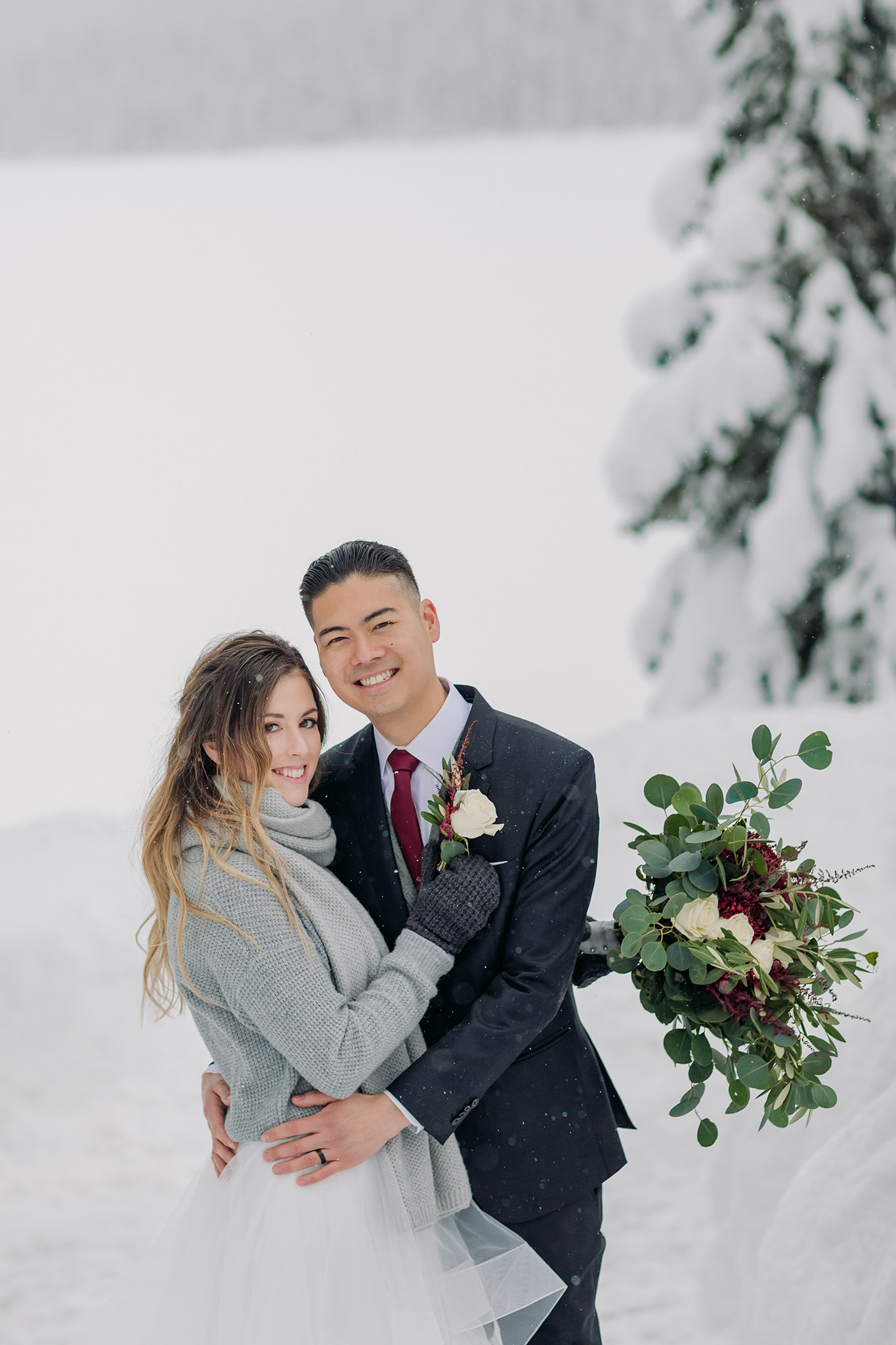 Snowy winter elopement at Emerald Lake Lodge in Yoho National Park. Outdoor winter wedding ceremony at the Viewpoint overlooking mountains & forest.