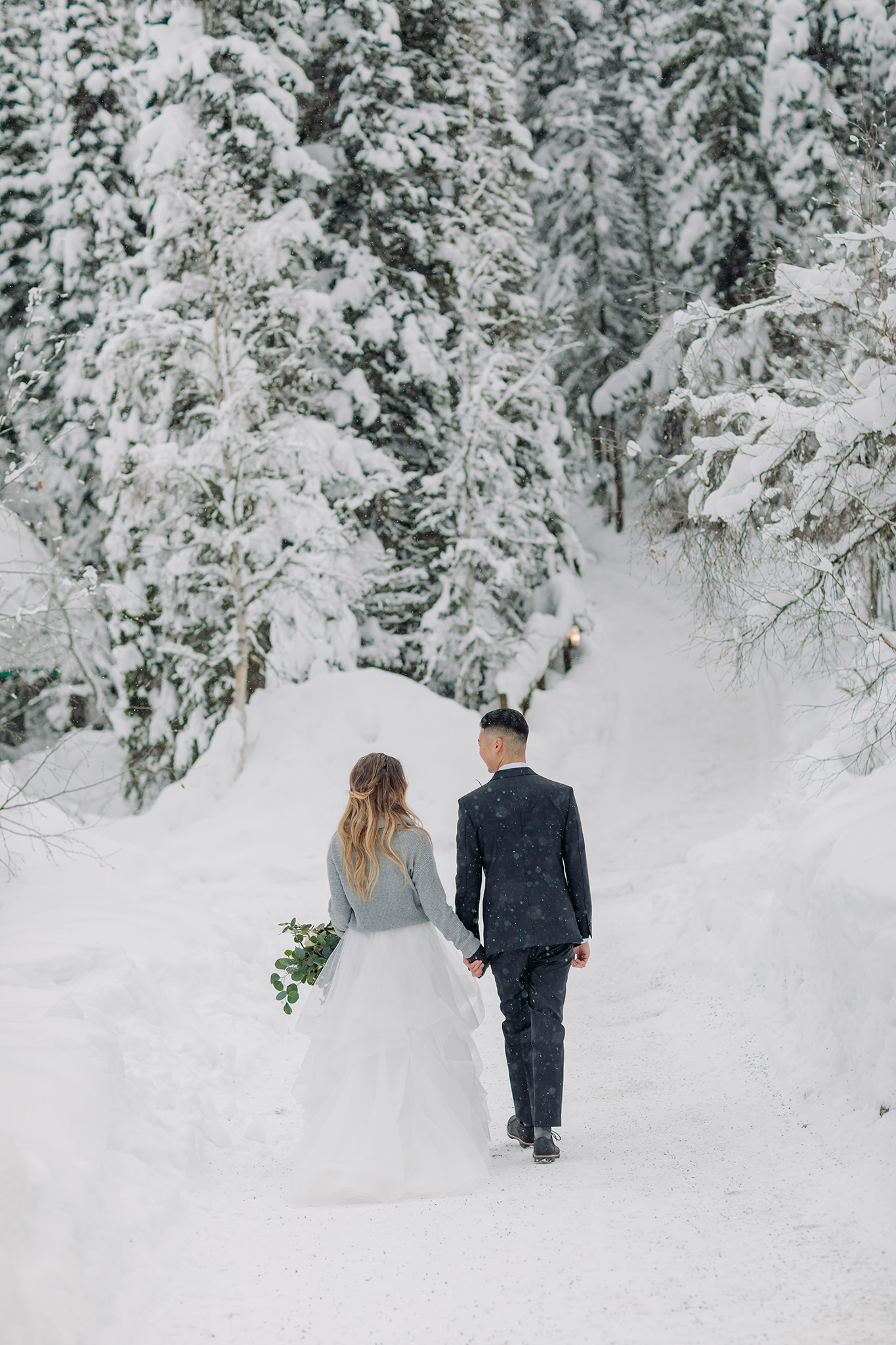 Walking in a winter wonderland at Emerald Lake Lodge mountain wedding