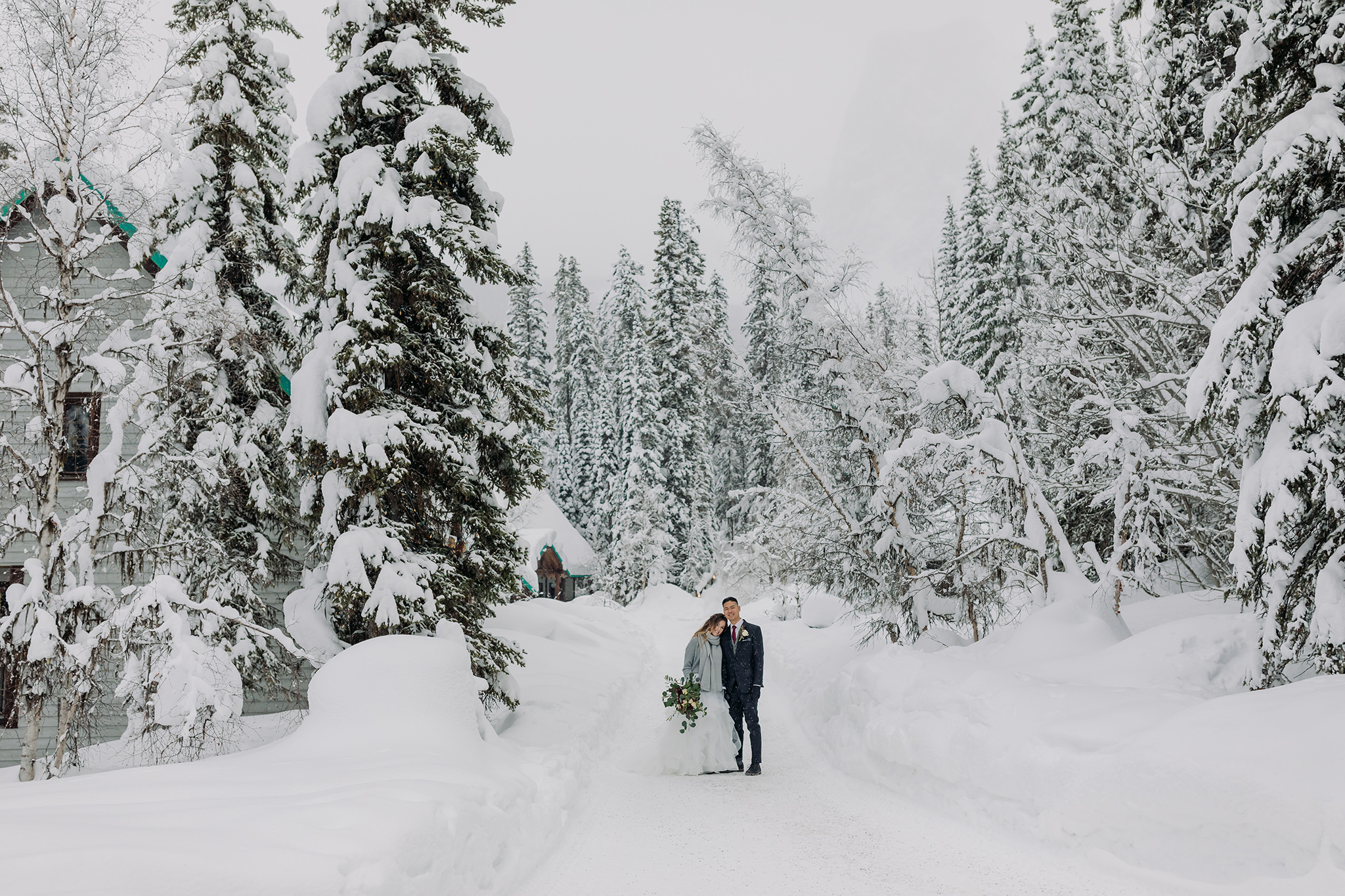 Snowy winter elopement at Emerald Lake Lodge in Yoho National Park. Mountain wedding in a winter wonderland. Bride in a cozy sweater & matching scarf to keep warm. What to wear for a winter wedding. 