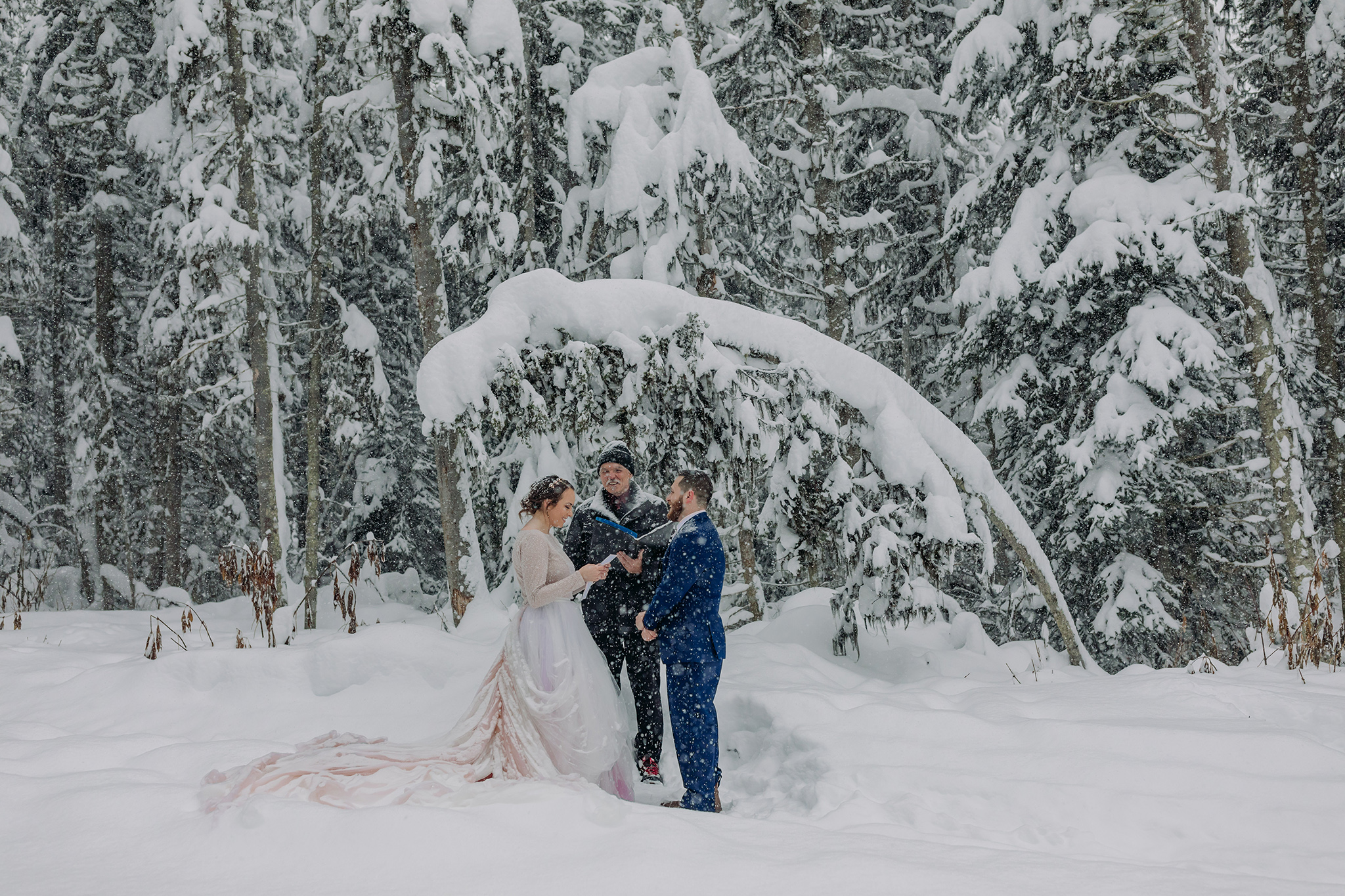 Elope in Lake Louise with a magical snowy outdoor winter wonderland forest wedding ceremony