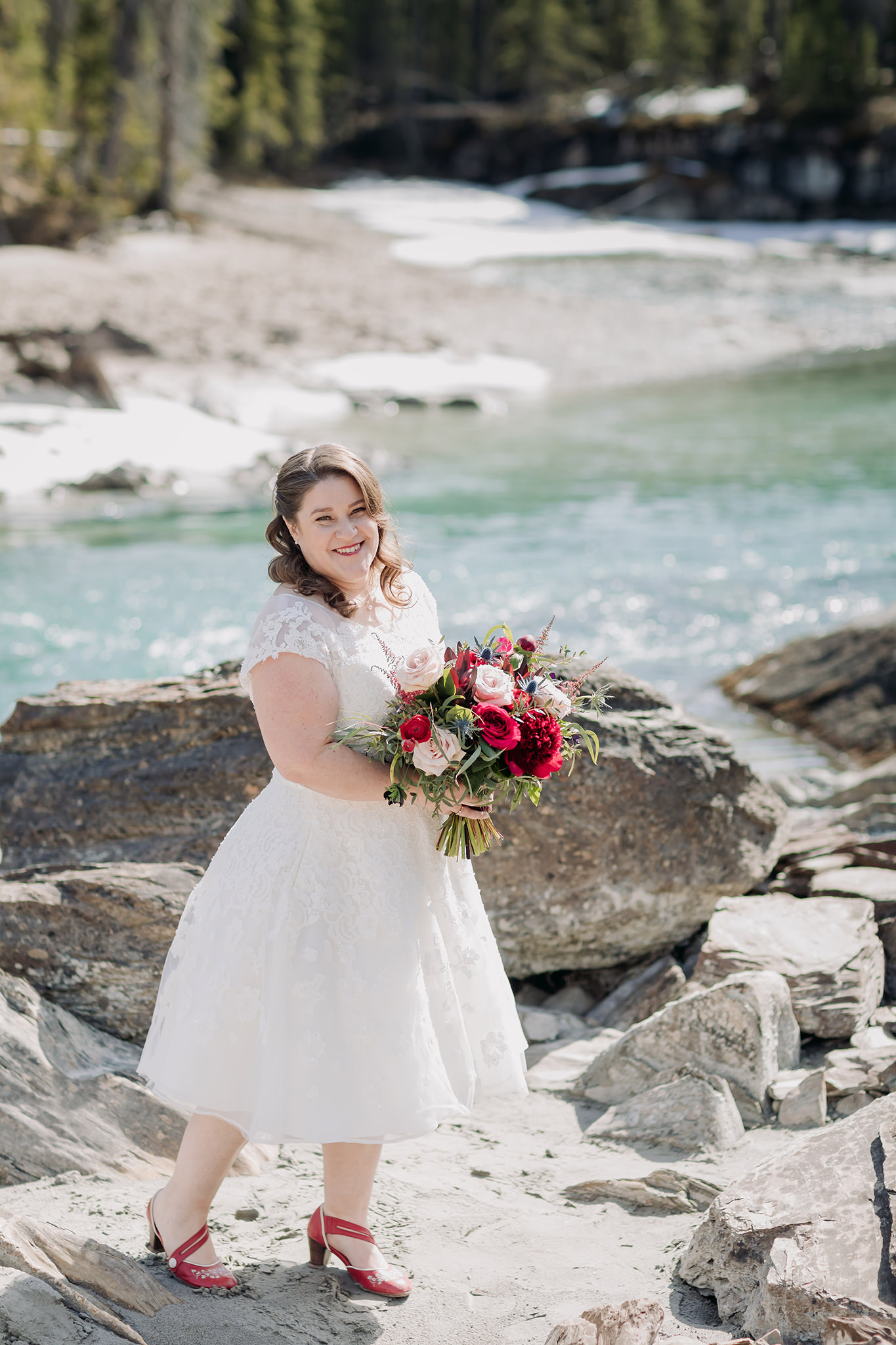 Emerald Lake Lodge bride portraits at the nearby Natural Bridge in Yoho National Park in late April
