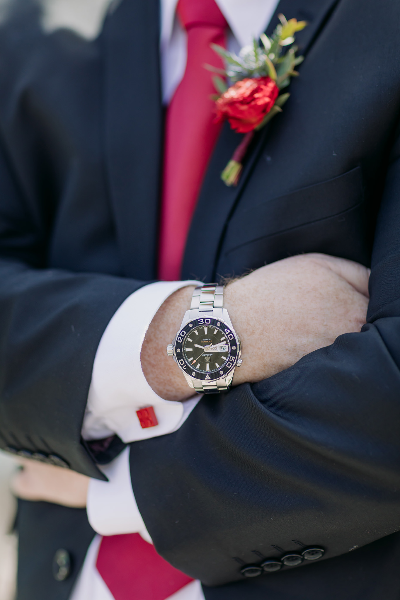 groom wedding details lego cuff links, watch & red boutonniere