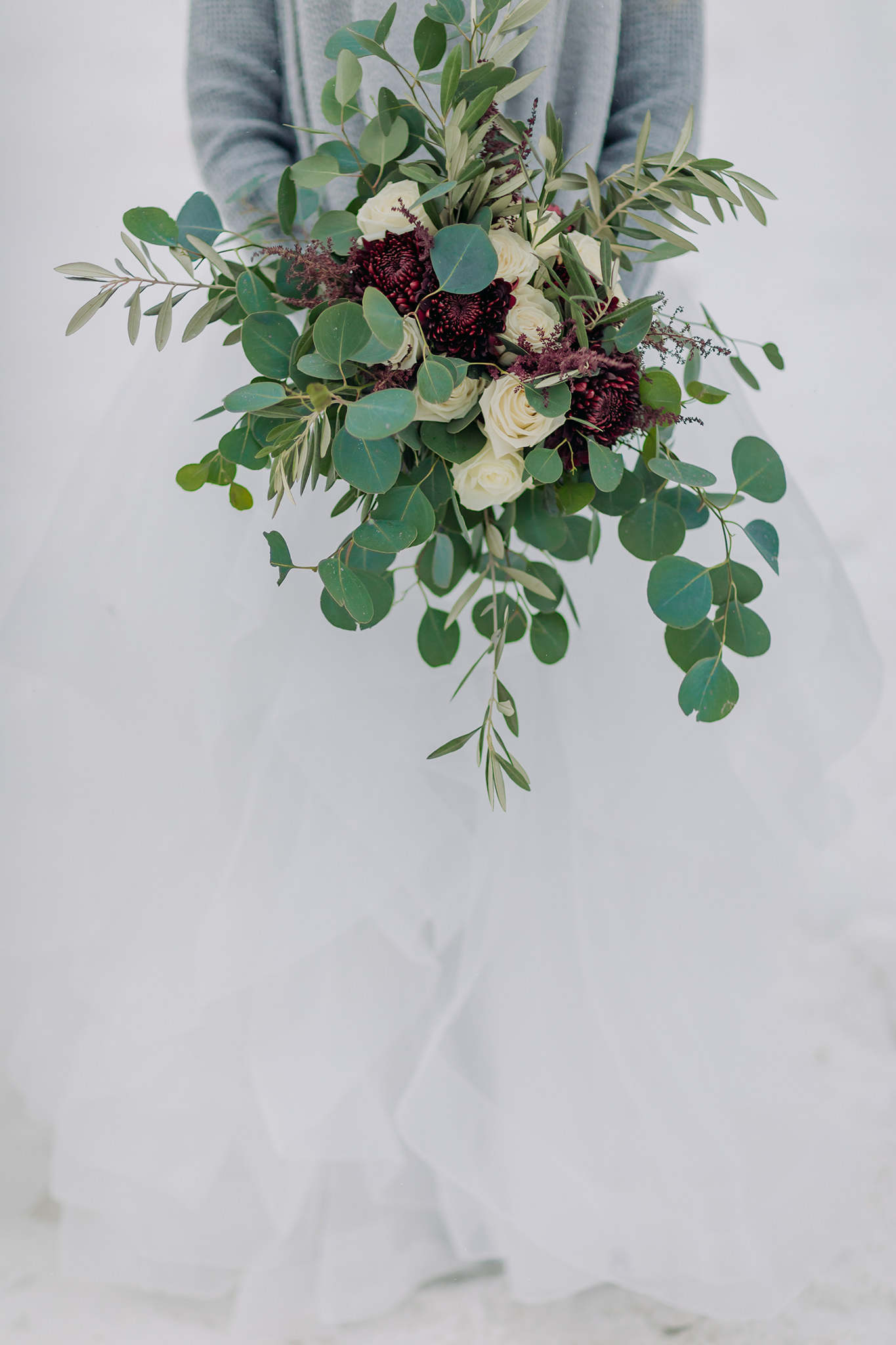 Winter wedding bouquet in burgundy, ivory & green.