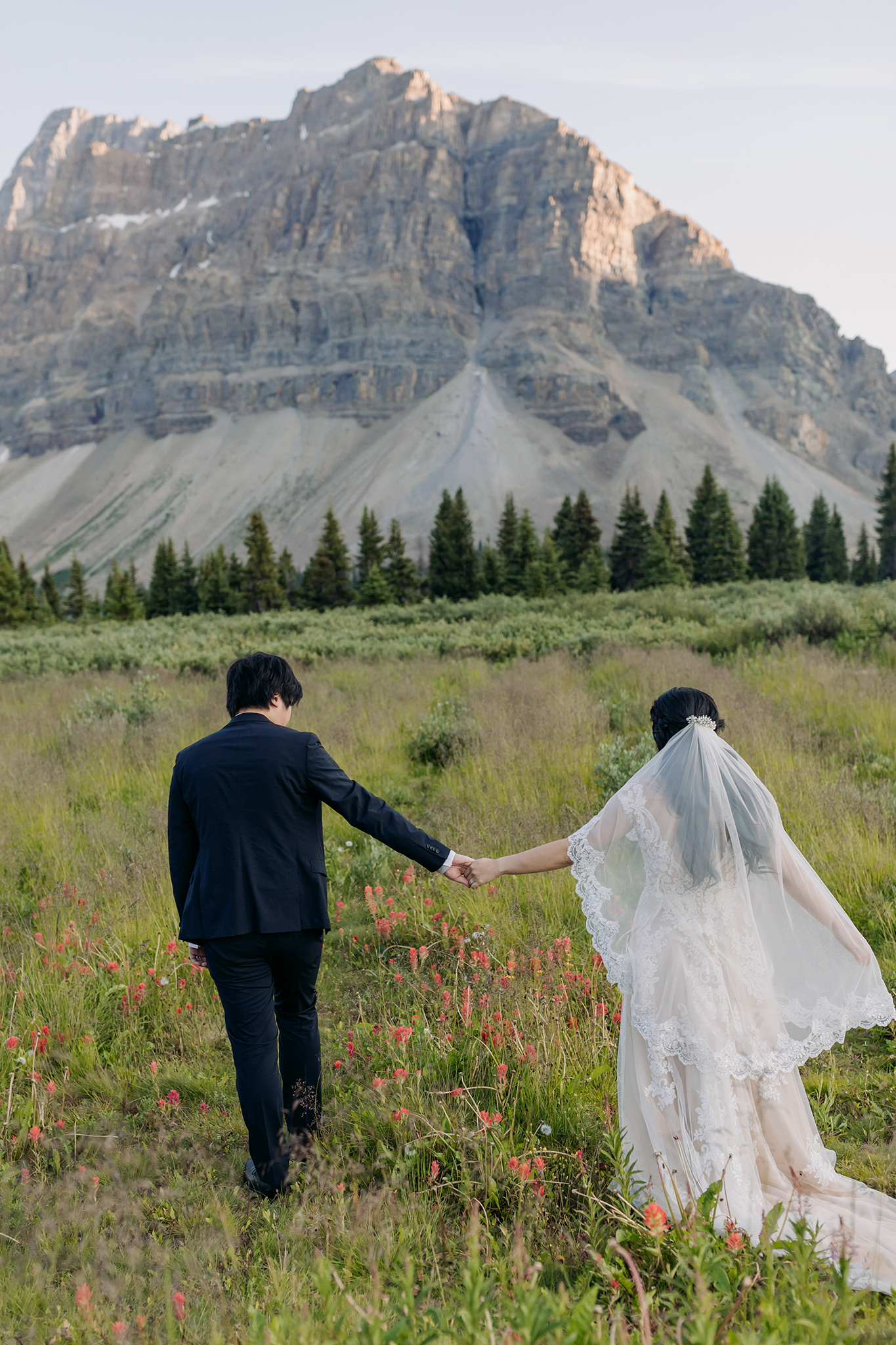 walking bride groom portraits at Bow Lake on Icefields near sunset in Banff National Park photographed by mountain elopement specialist ENV Photography