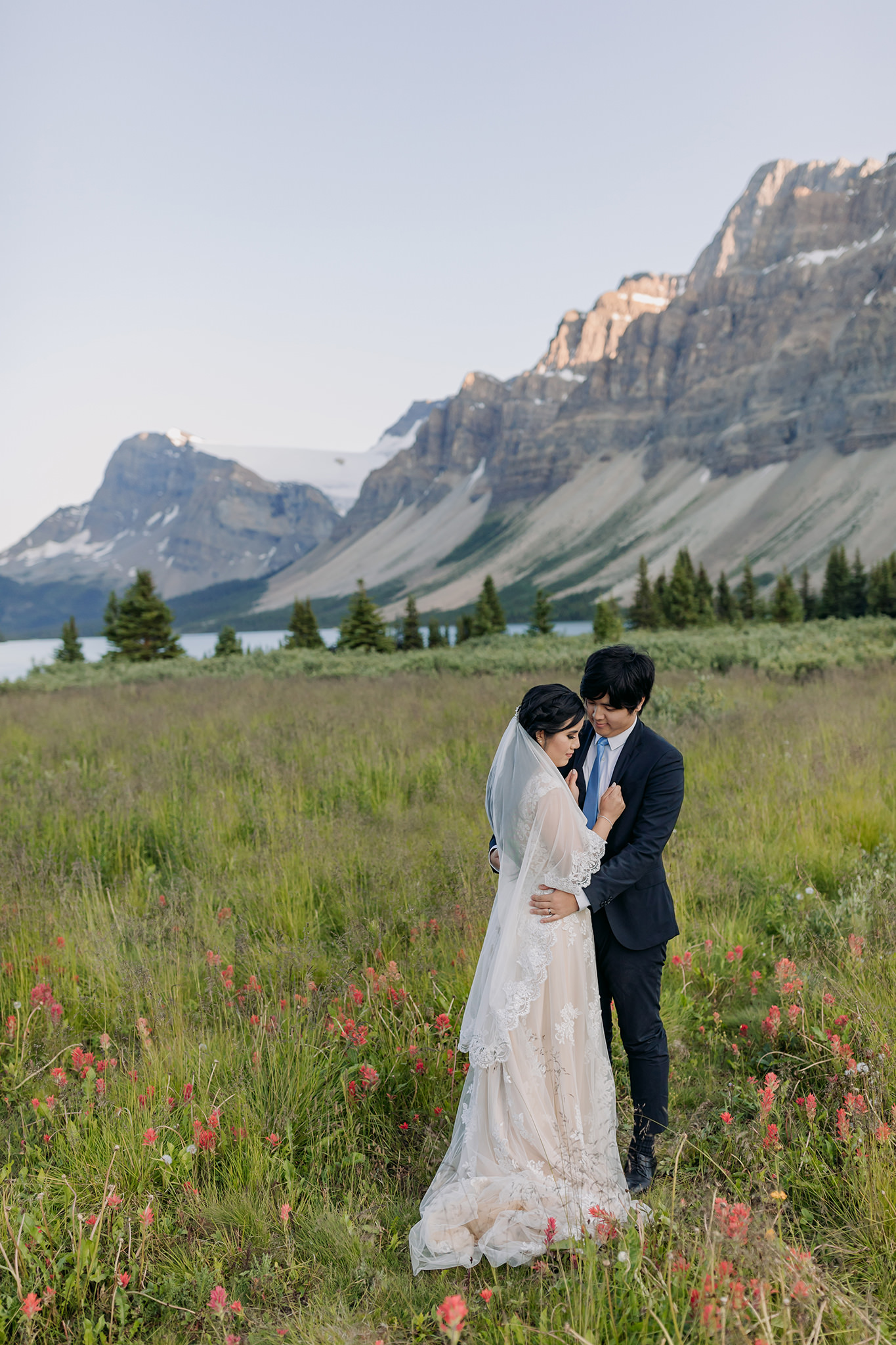 Rocky Mountain wedding tour bride groom portraits at Bow Lake on Icefields near sunset in Banff National Park photographed by mountain elopement specialist ENV Photography
