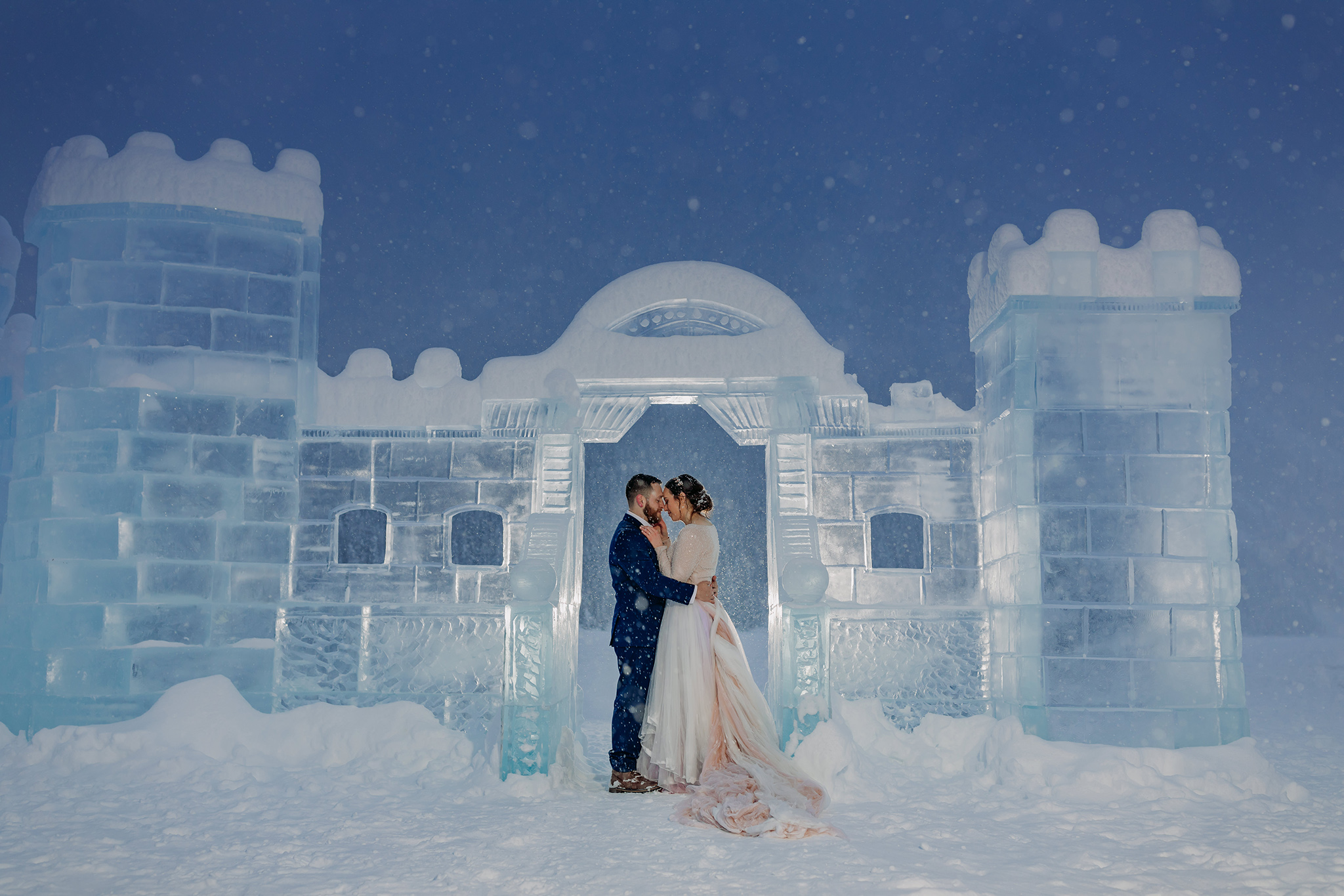 Elope in Lake Louise with magical snowy outdoor winter wonderland wedding photos at the Fairmont Chateau Lake Louise Ice Castle at Twilight