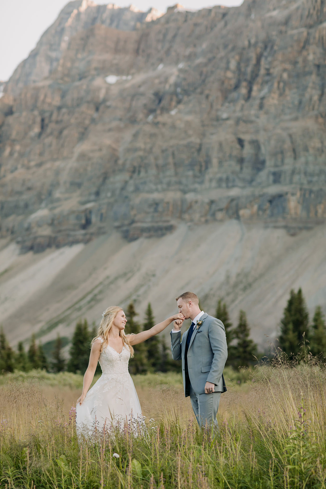 Exploring Icefields Parkway in Banff National Park on their wedding day. Summer mountain elopement at Bow Lake photographed by local wedding & elopement photographer ENV Photography 