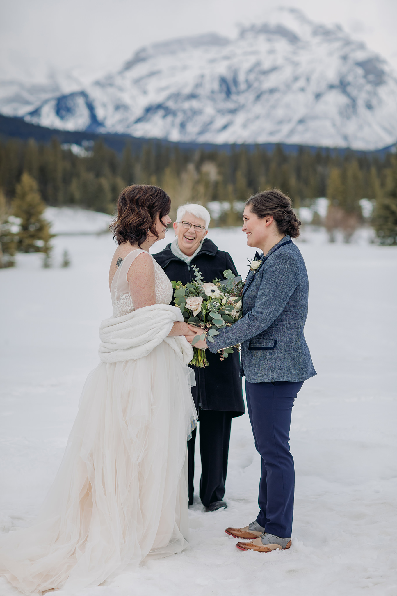 banff intimate same-sex gay wedding ceremony outside at cascade ponds in winter
