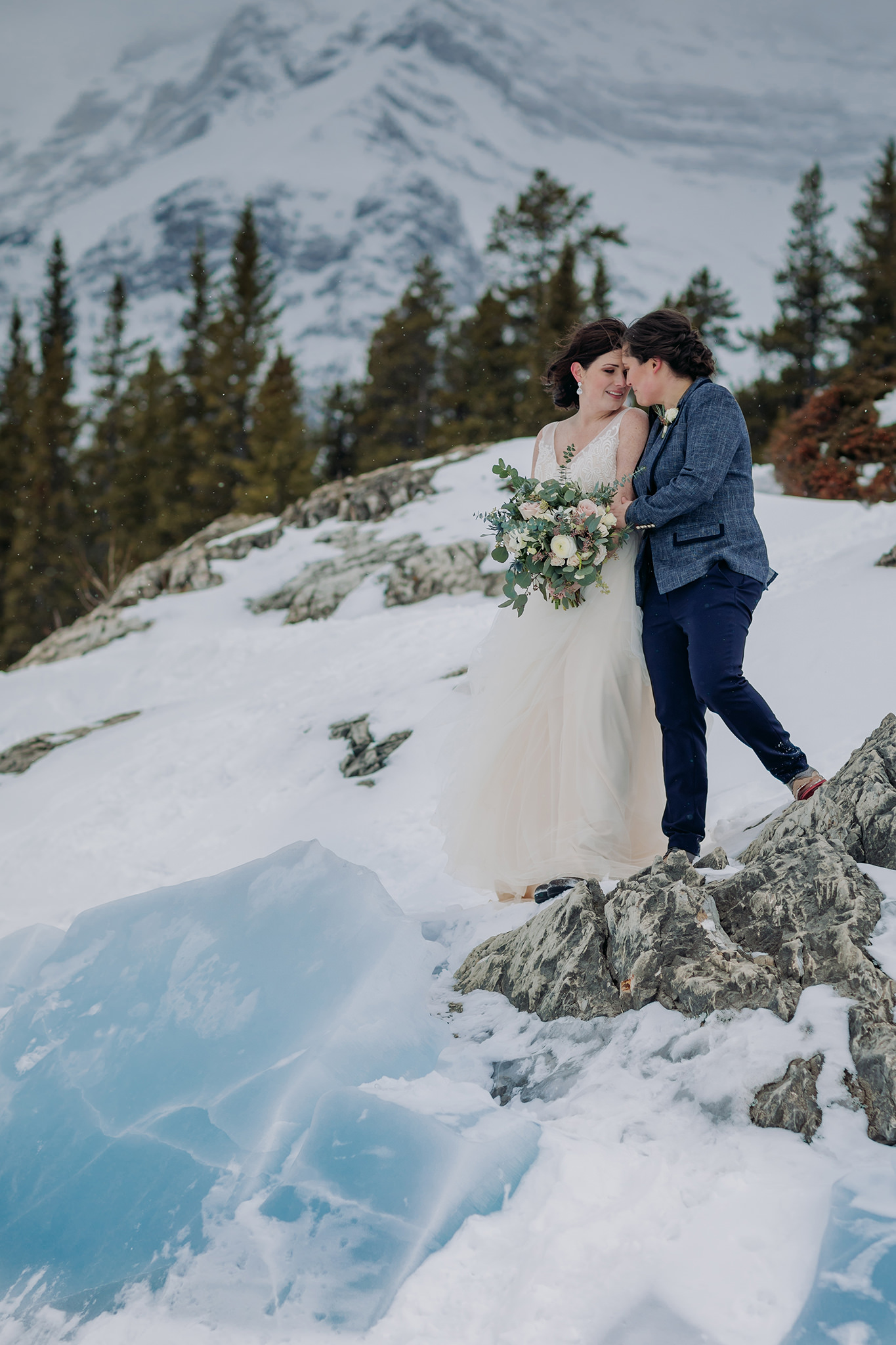LGBTQ gay elopement in the mountains in winter lake minnewanka