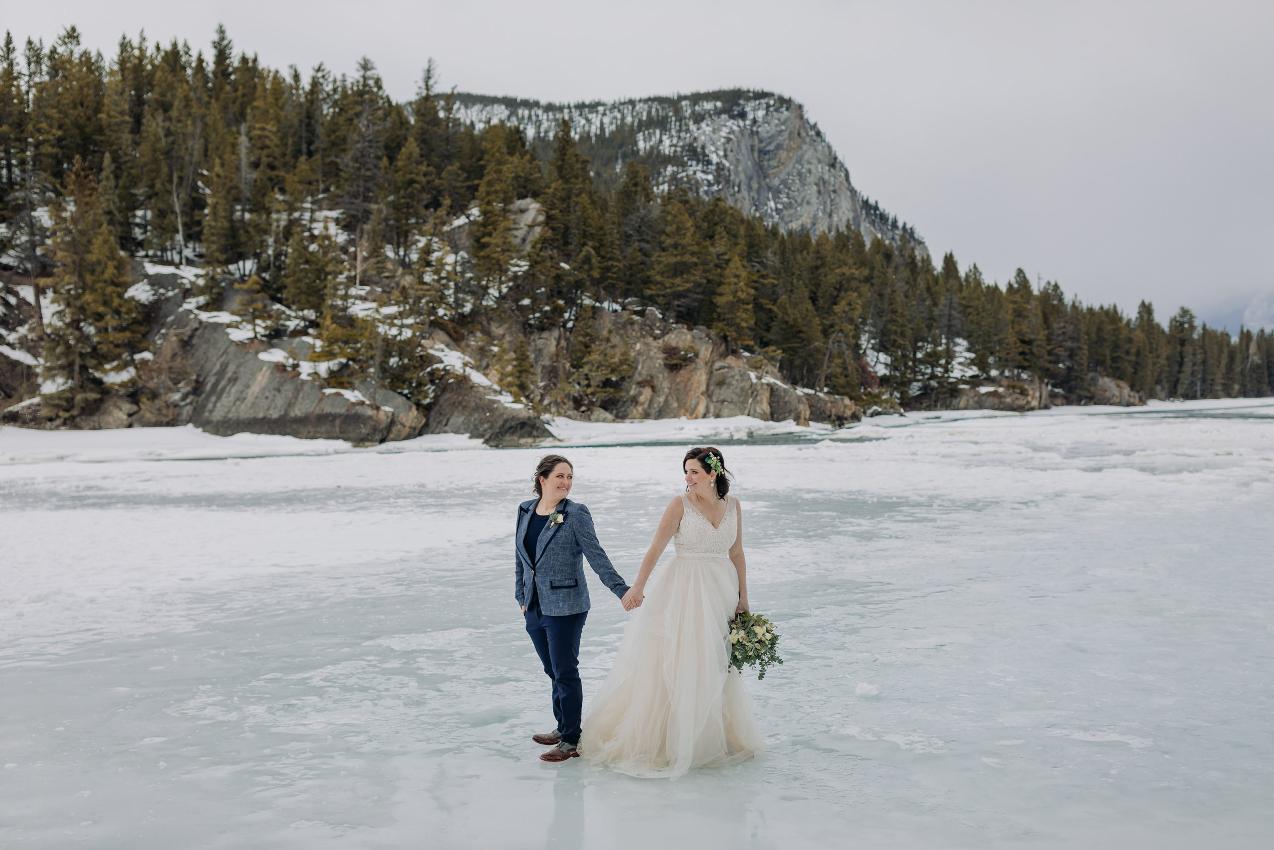 LGBTQ gay elopement in the mountains in winter bow falls