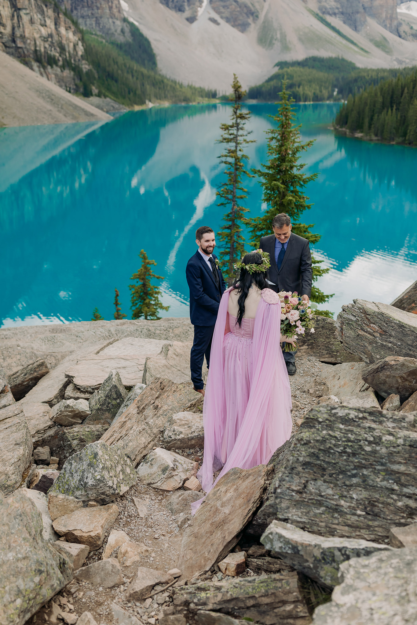 how to elope at moraine lake wedding ceremony for elopement atop the rockpile surrounded by mountains and reflecting turquoise waters