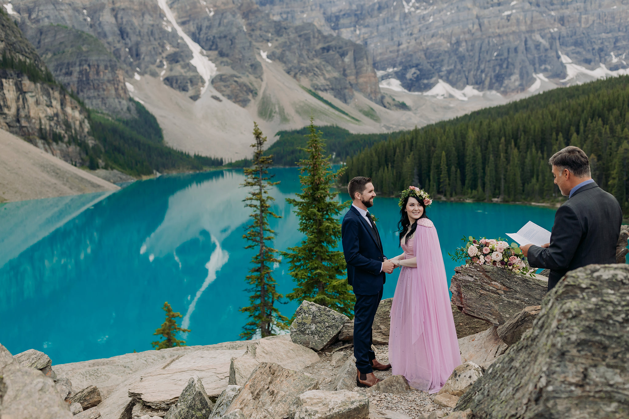 how to elope at moraine lake wedding ceremony for elopement atop the rockpile surrounded by mountains and reflecting turquoise waters