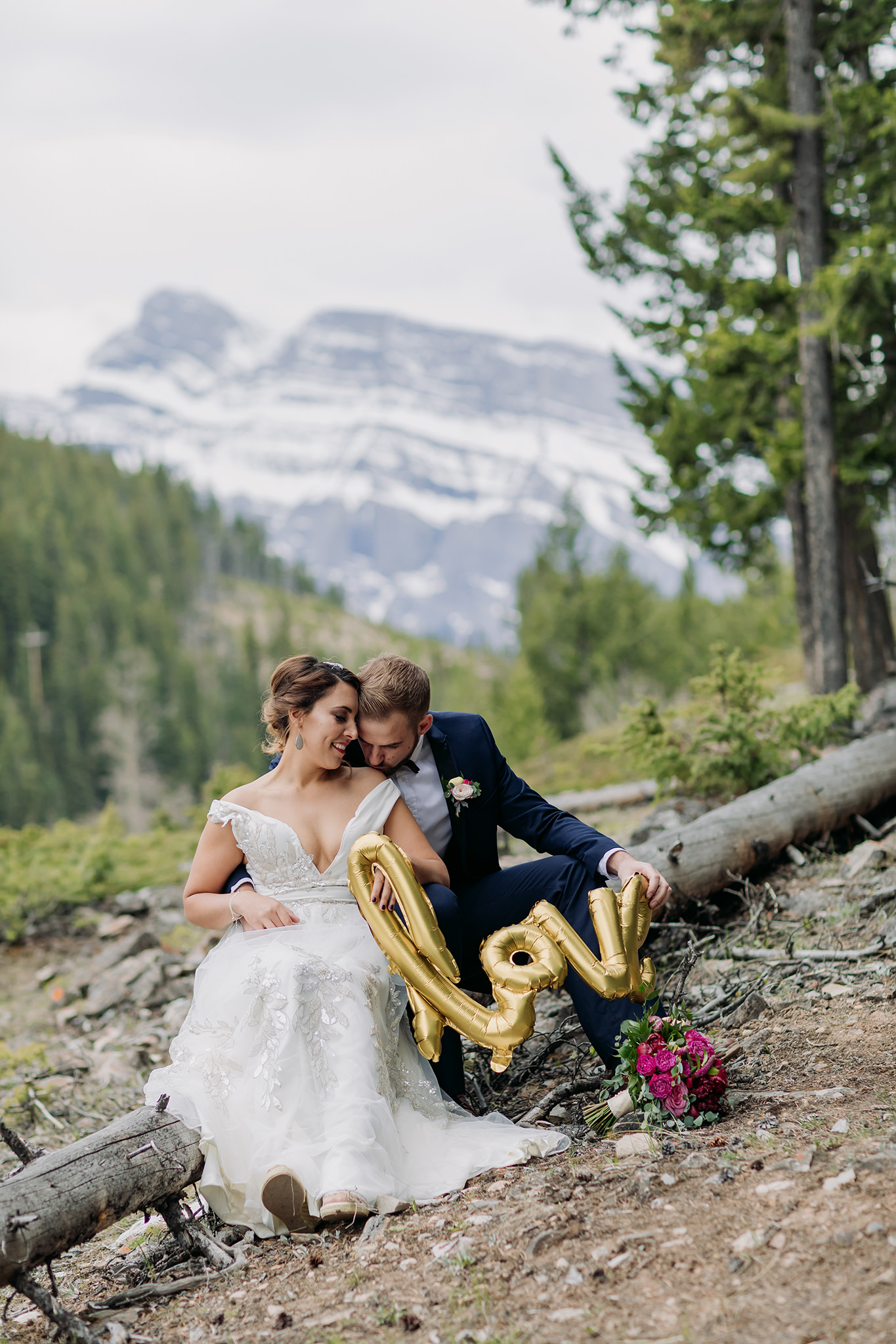 Intimate wedding portraits in Banff with cute gold foil LOVE balloon