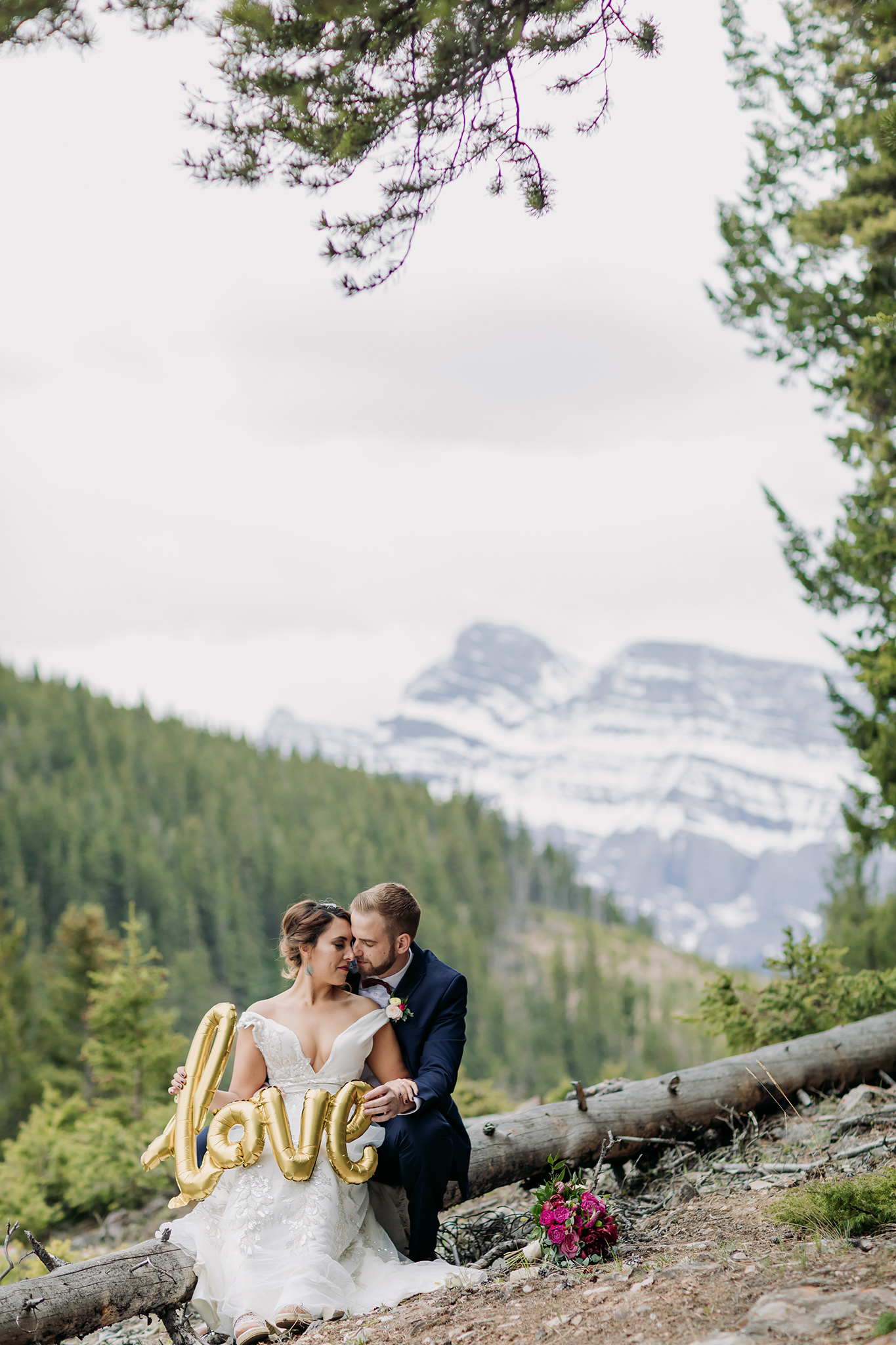 Intimate wedding portraits in Banff with cute gold foil LOVE balloon