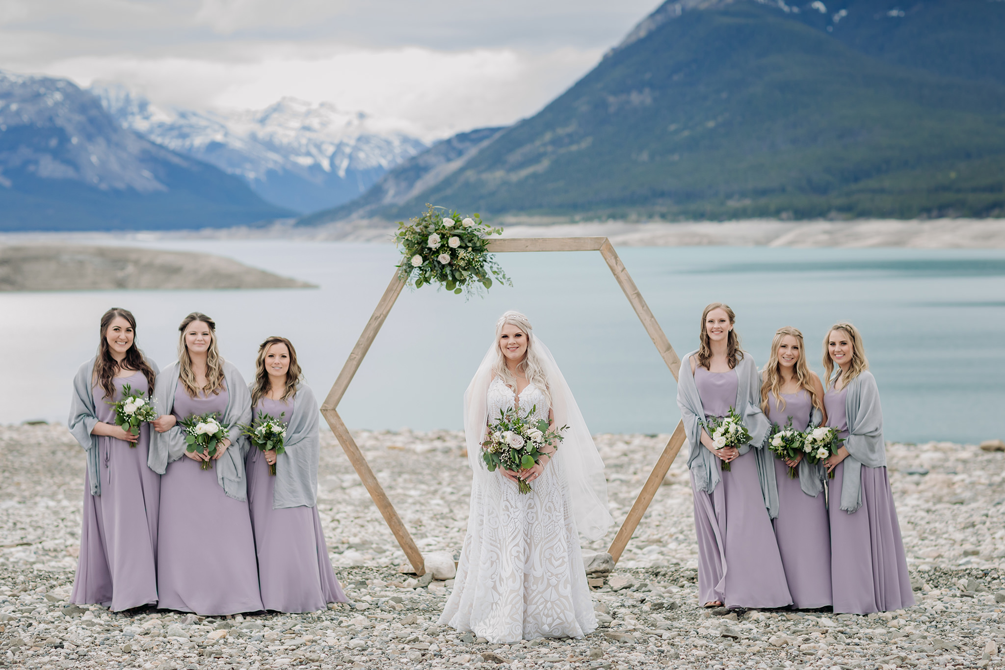 Abraham Lake Spring Mountain wedding with outdoor wedding portraits blue waters & mountains in the distance bridal party portraits