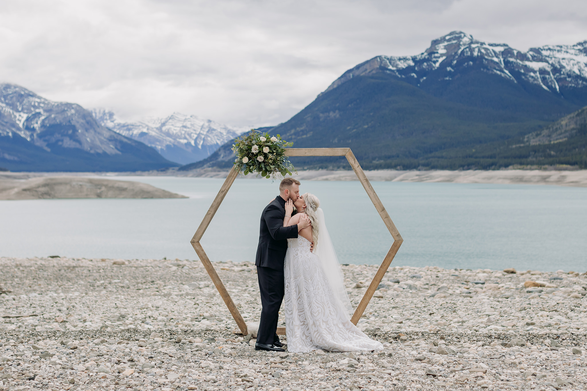 Abraham Lake Spring Mountain wedding with outdoor wedding portraits blue waters & mountains in the distance