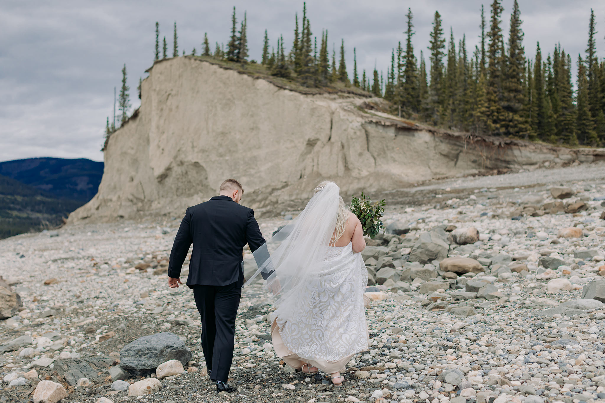 Abraham Lake Spring Mountain wedding with outdoor wedding portraits blue waters & mountains in the distance