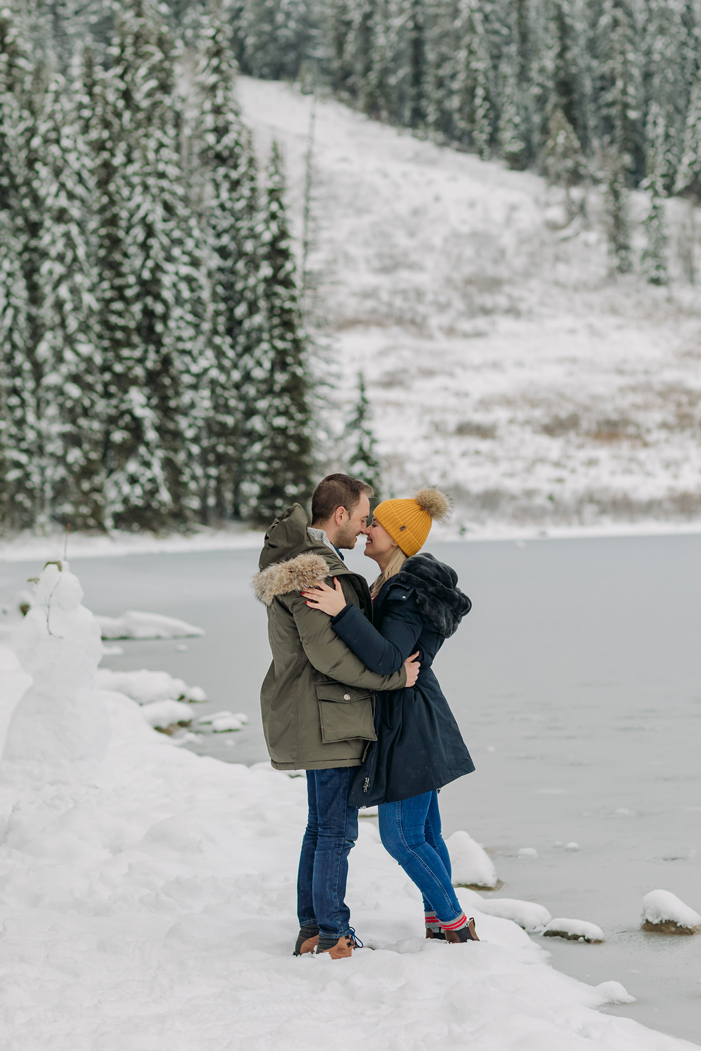 emerald lake winter engagement photos with freshly frozen lake & colourful style