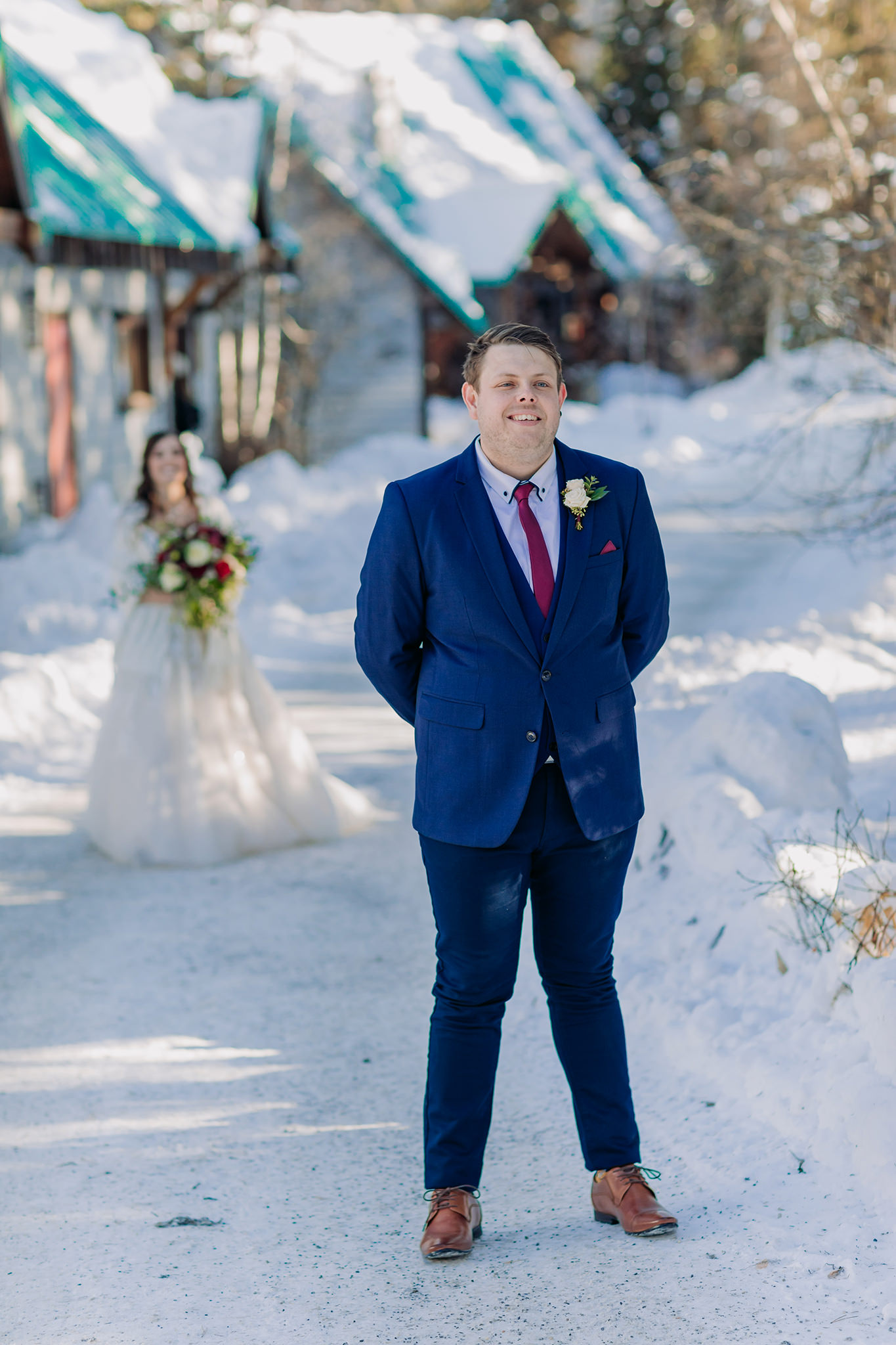 snowy first look between bride & groom at Emerald Lake Lodge in the mountains