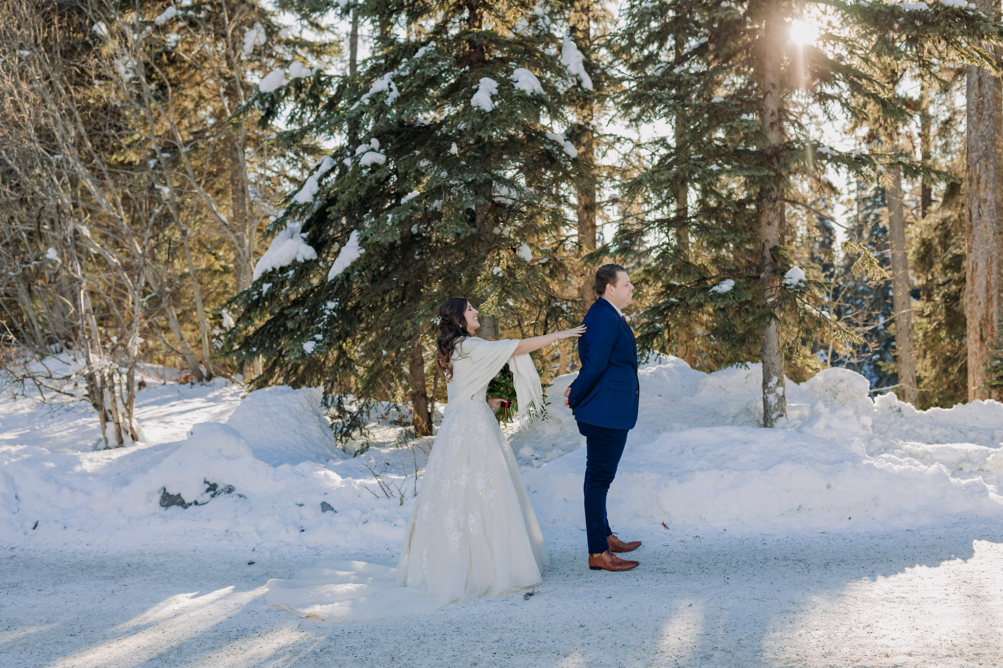 snowy first look between bride & groom at Emerald Lake Lodge in the mountains