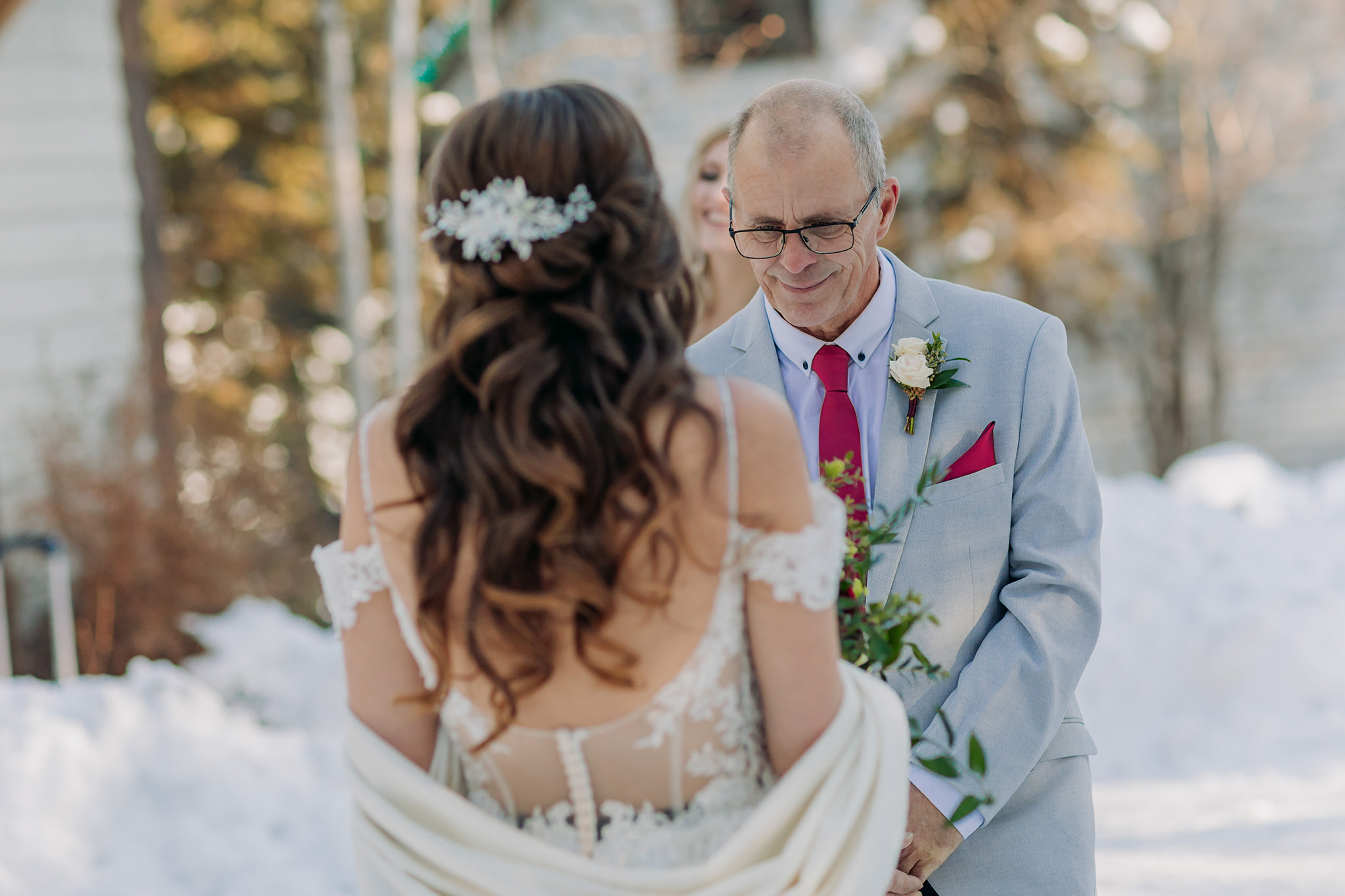 snowy first look between bride & her dad at Emerald Lake Lodge in the mountains