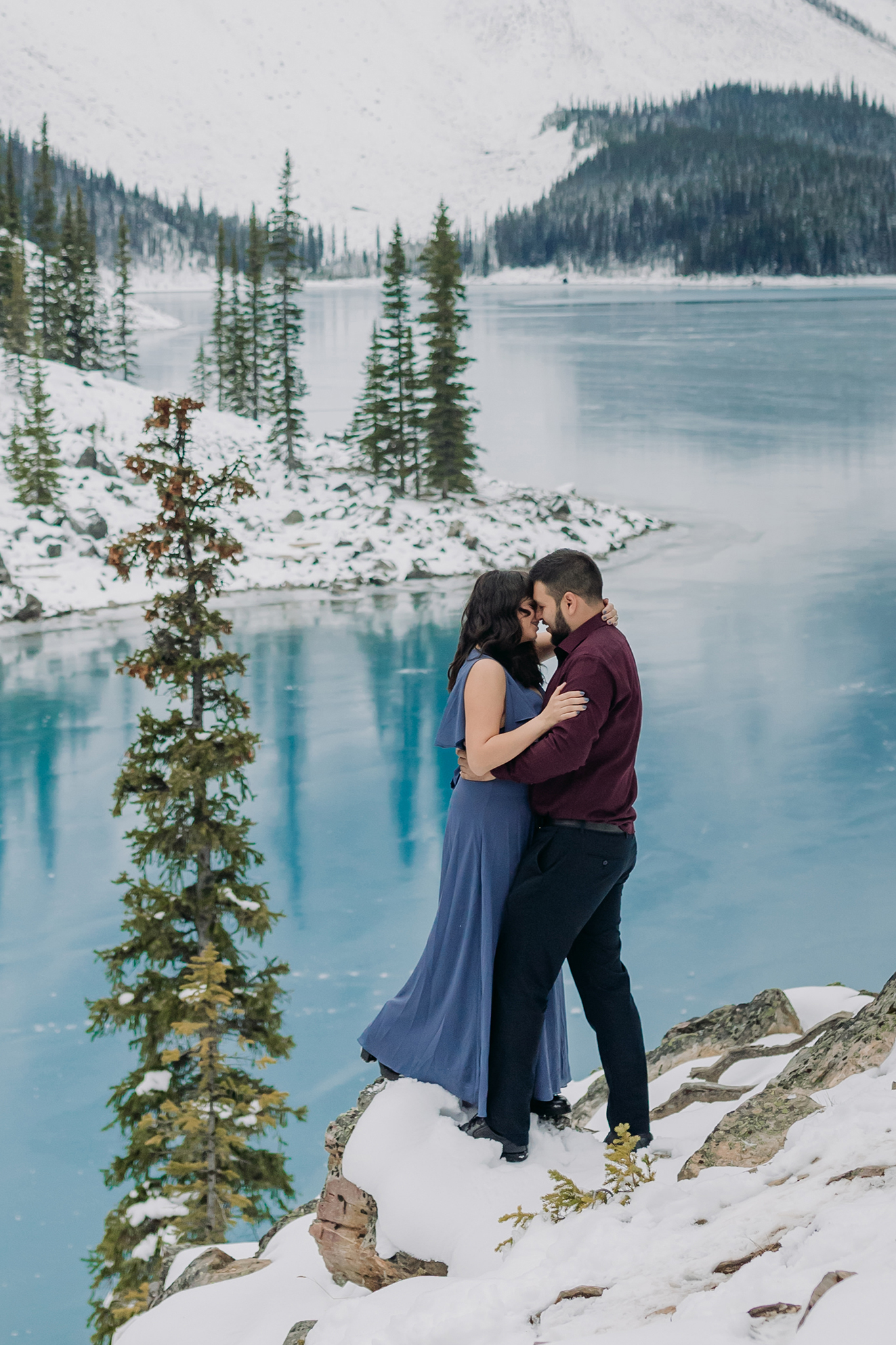 Moraine Lake in October: Freshly frozen mountain lake with blue ice makes stunning backdrop for engagement photos