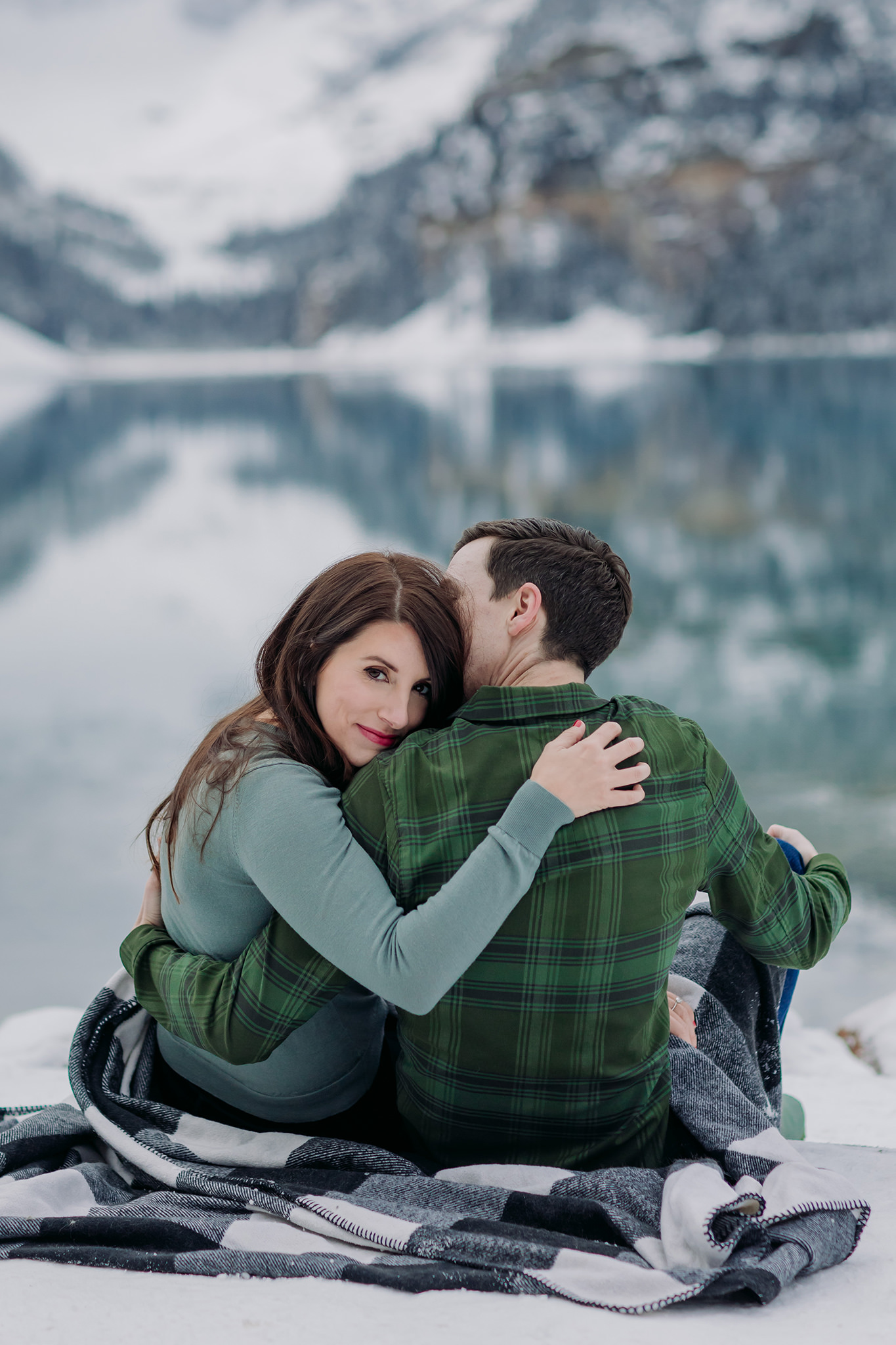 Casual Canadian Rocky Mountain engagement session in autumn with fresh snow and stunning turquoise water
