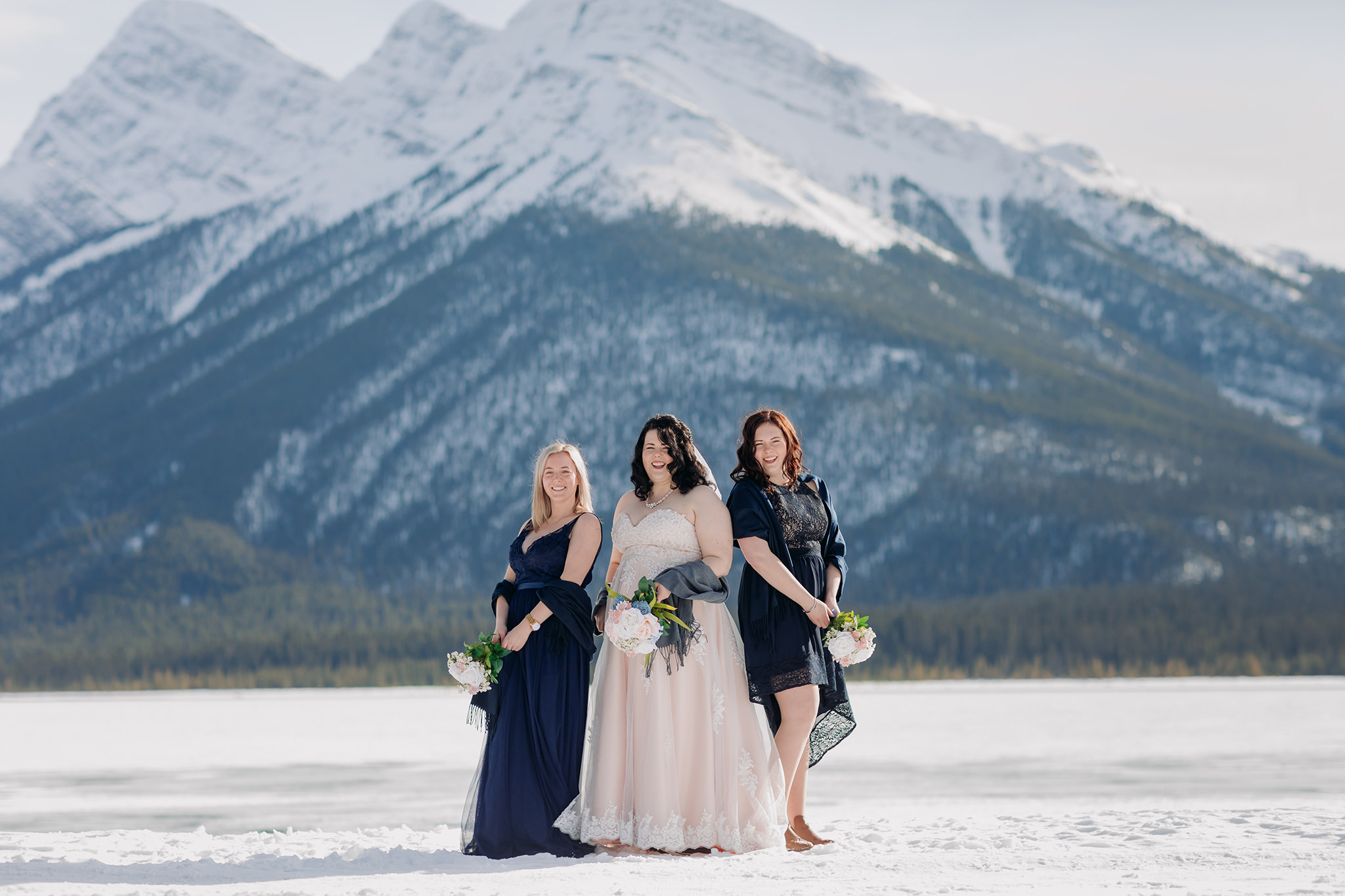 Falcon Crest Lodge wedding Canmore winter wedding photos wedding party at Goat Pond in Kananaskis photographed by ENV Photography