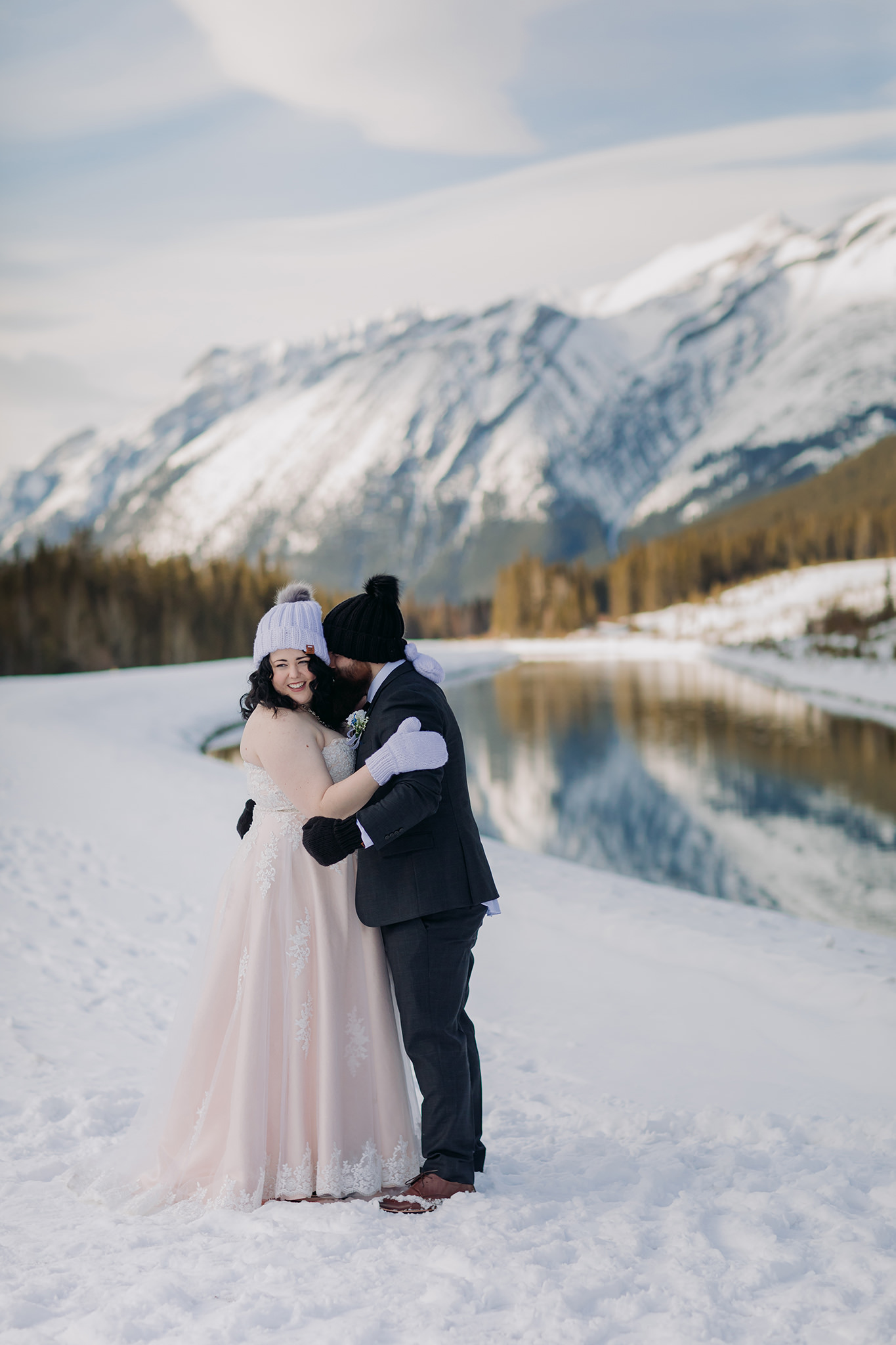 Falcon Crest Lodge wedding Canmore winter wedding photos bride & groom at Goat Pond in Kananaskis photographed by ENV Photography wool hats mittens