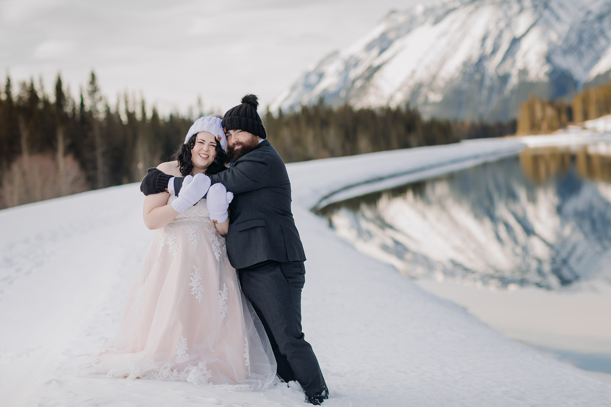 Falcon Crest Lodge wedding Canmore winter wedding photos bride & groom at Goat Pond in Kananaskis photographed by ENV Photography woolen hats mittens