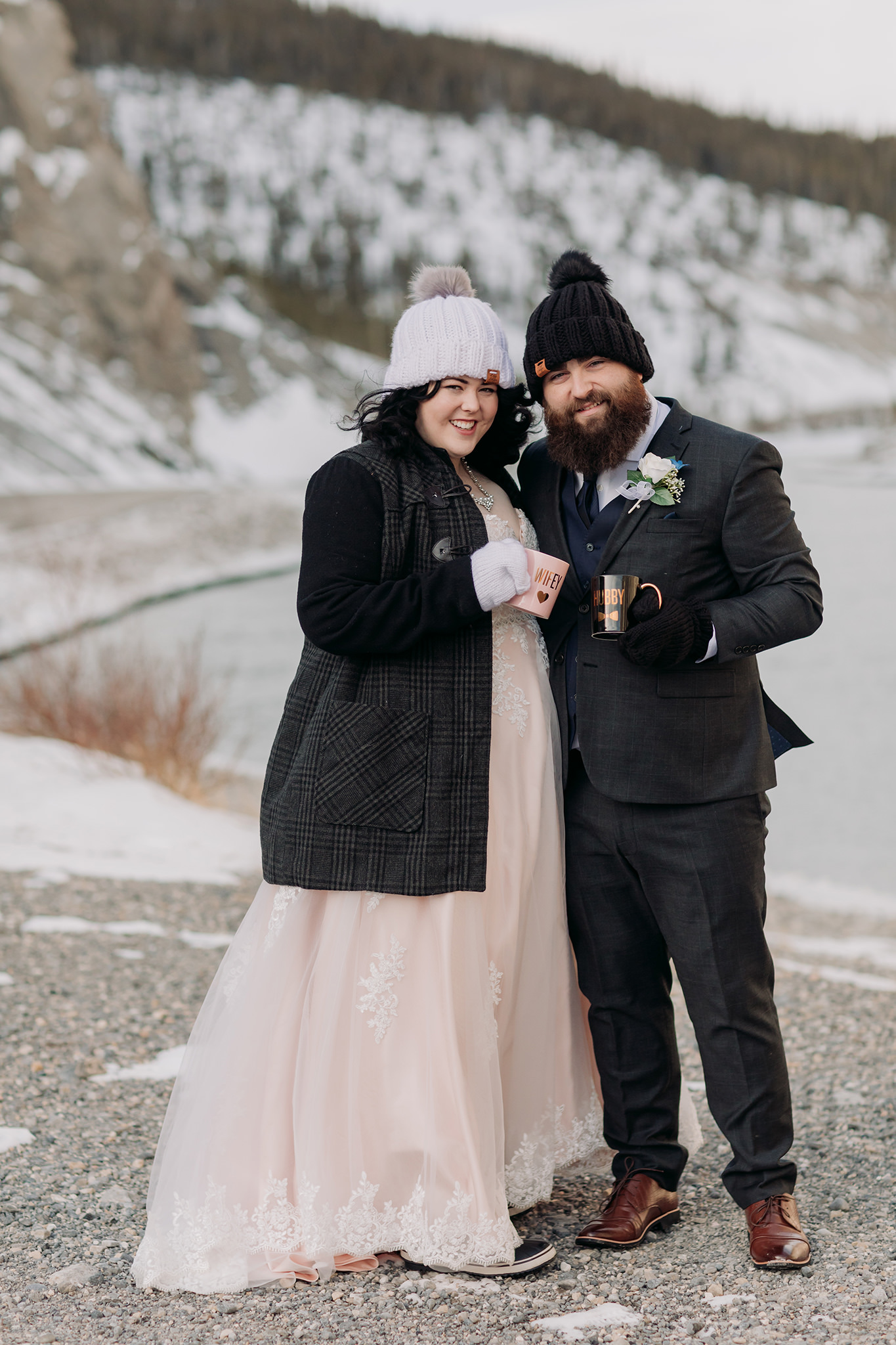 Falcon Crest Lodge wedding Canmore winter wedding photos bride & groom at Goat Pond in Kananaskis photographed by ENV Photography woolen hats mittens hubby wifey mugs