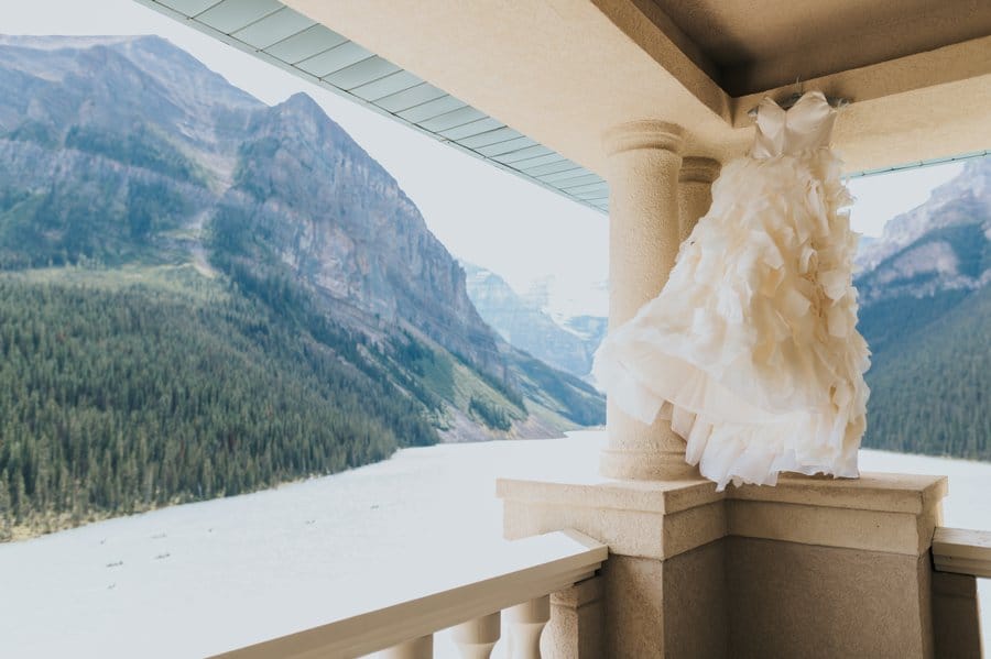 lake louise elopement elizabeth stuart wedding dress on the balcony at the Belvedere Suite