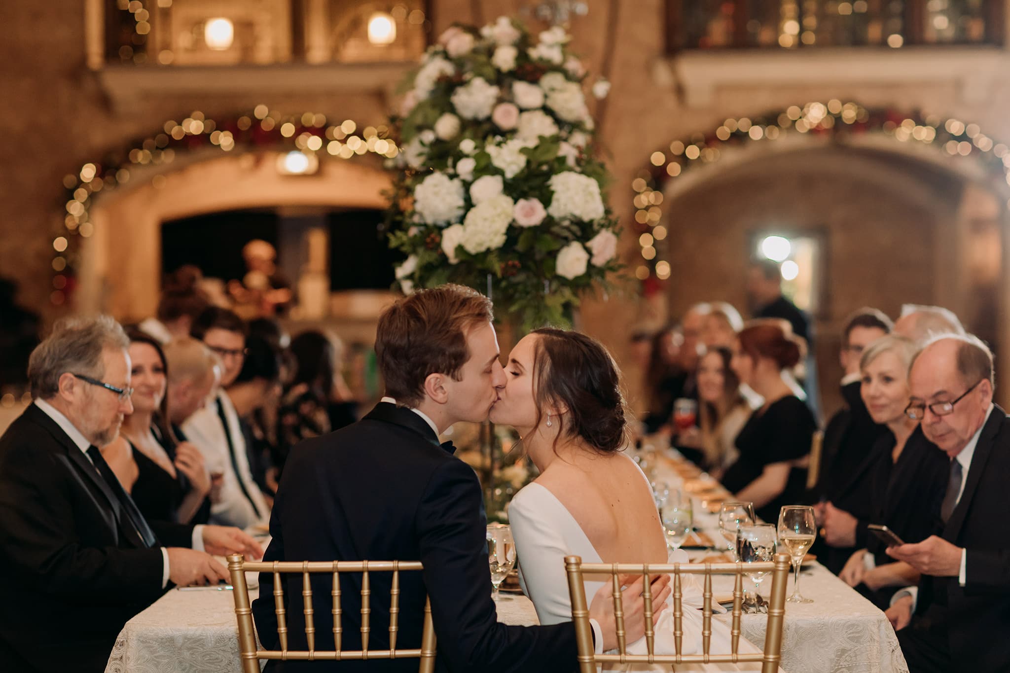 Fairmont Banff Springs winter wedding reception Mt Stephen Hall bride groom kissing at table