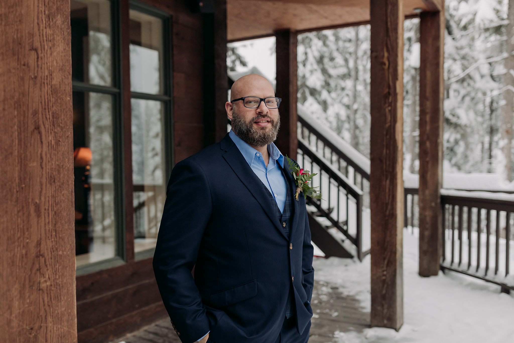elopement Bride & Groom first Look on the deck at the Main lodge with icicles & falling snow photographed by mountain elopement & wedding photographer ENV Photography