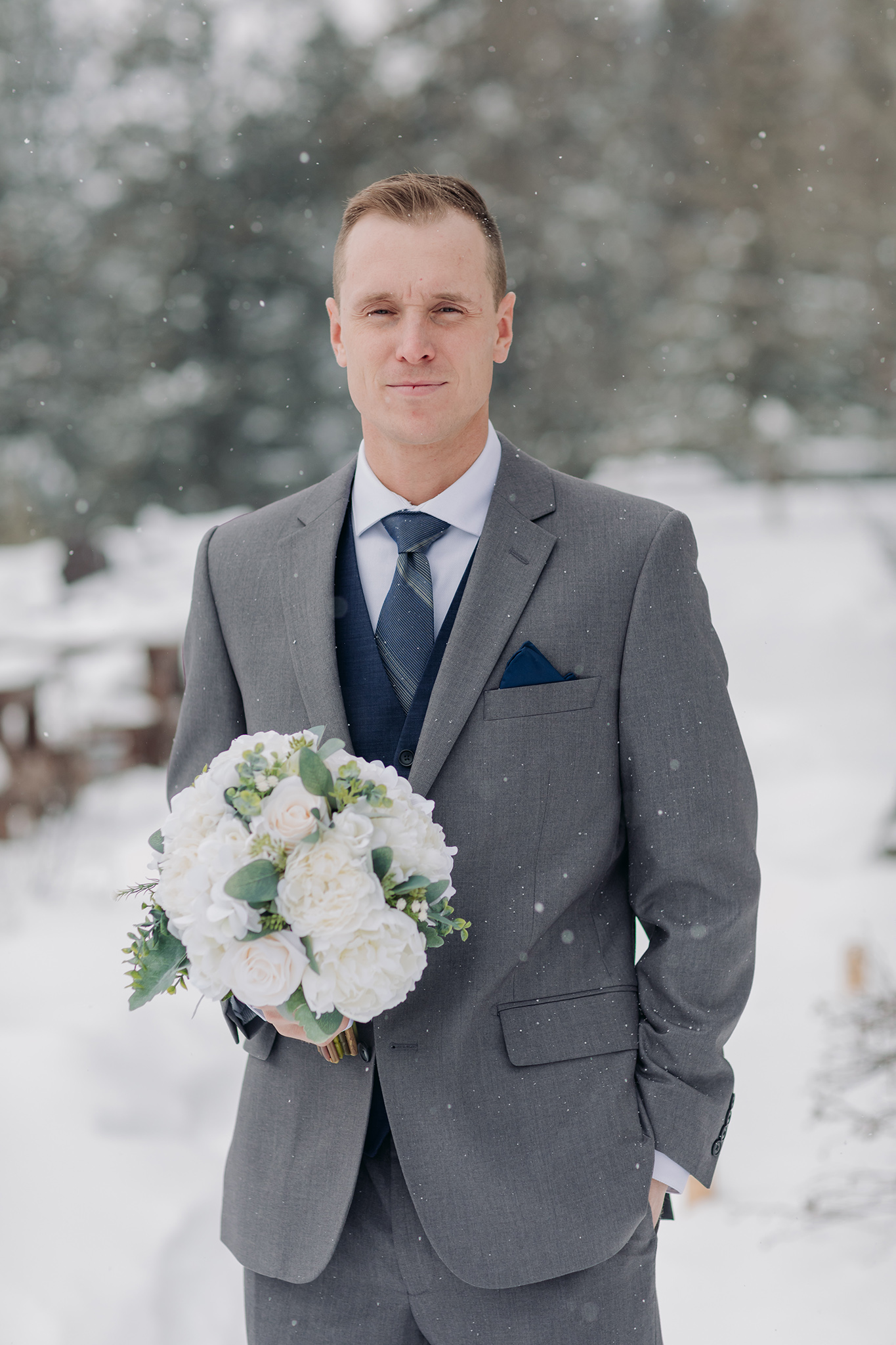 groom waiting for first look at Juniper Hotel in Banff National Park in a snow storm photographed by ENV Photography