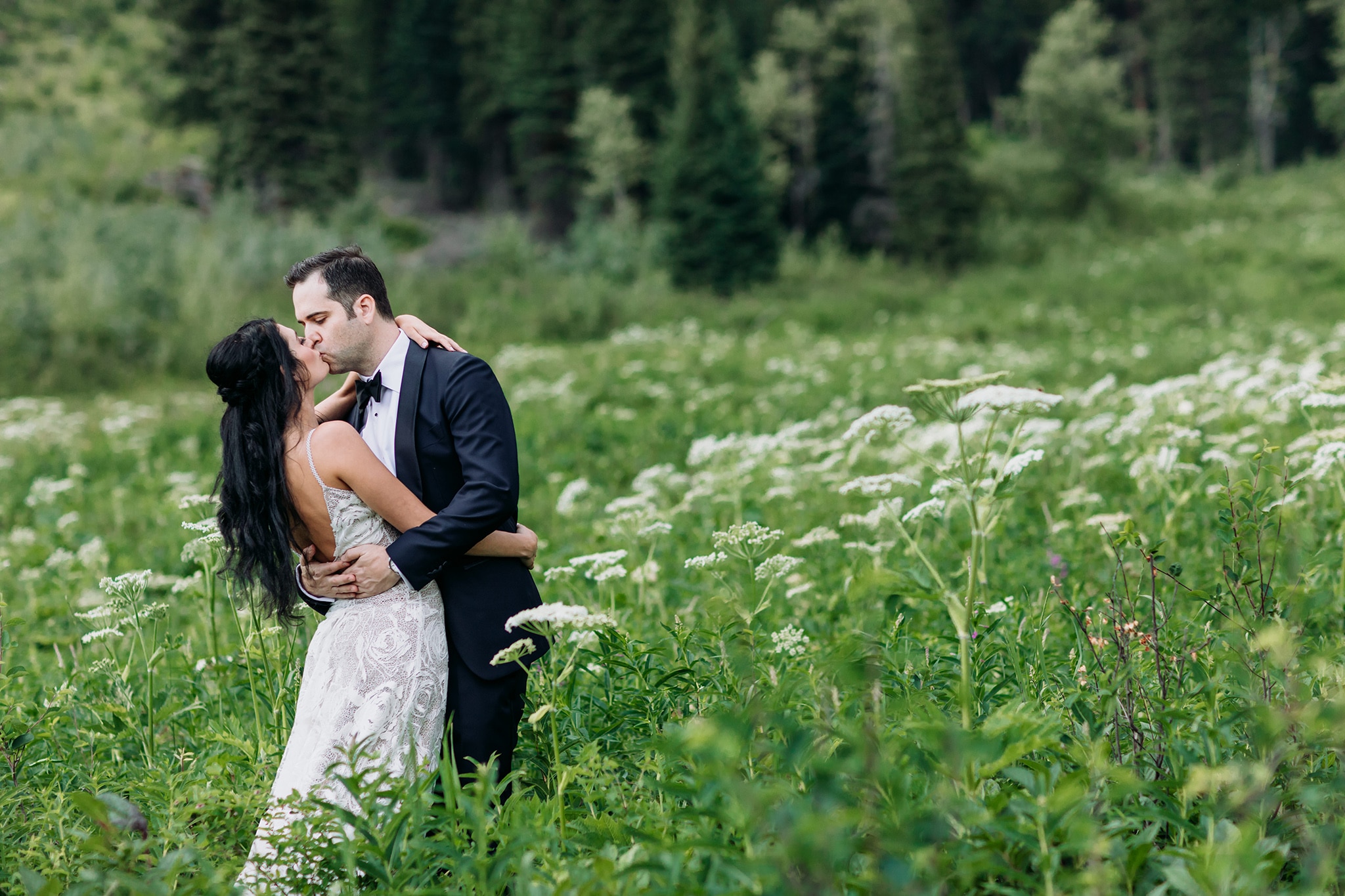 A Guide to Eloping in the Canadian Rockies | Mountain Wedding photographed by ENV Photography |Bride & groom in the flowers at Emerald lake Lodge