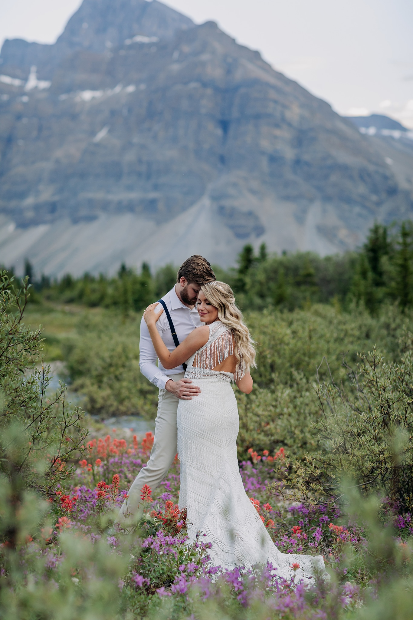 A Guide to Eloping in the Canadian Rockies | Mountain Wedding photographed by ENV Photography | boho mountain elopement in wildflowers on icefields parkway