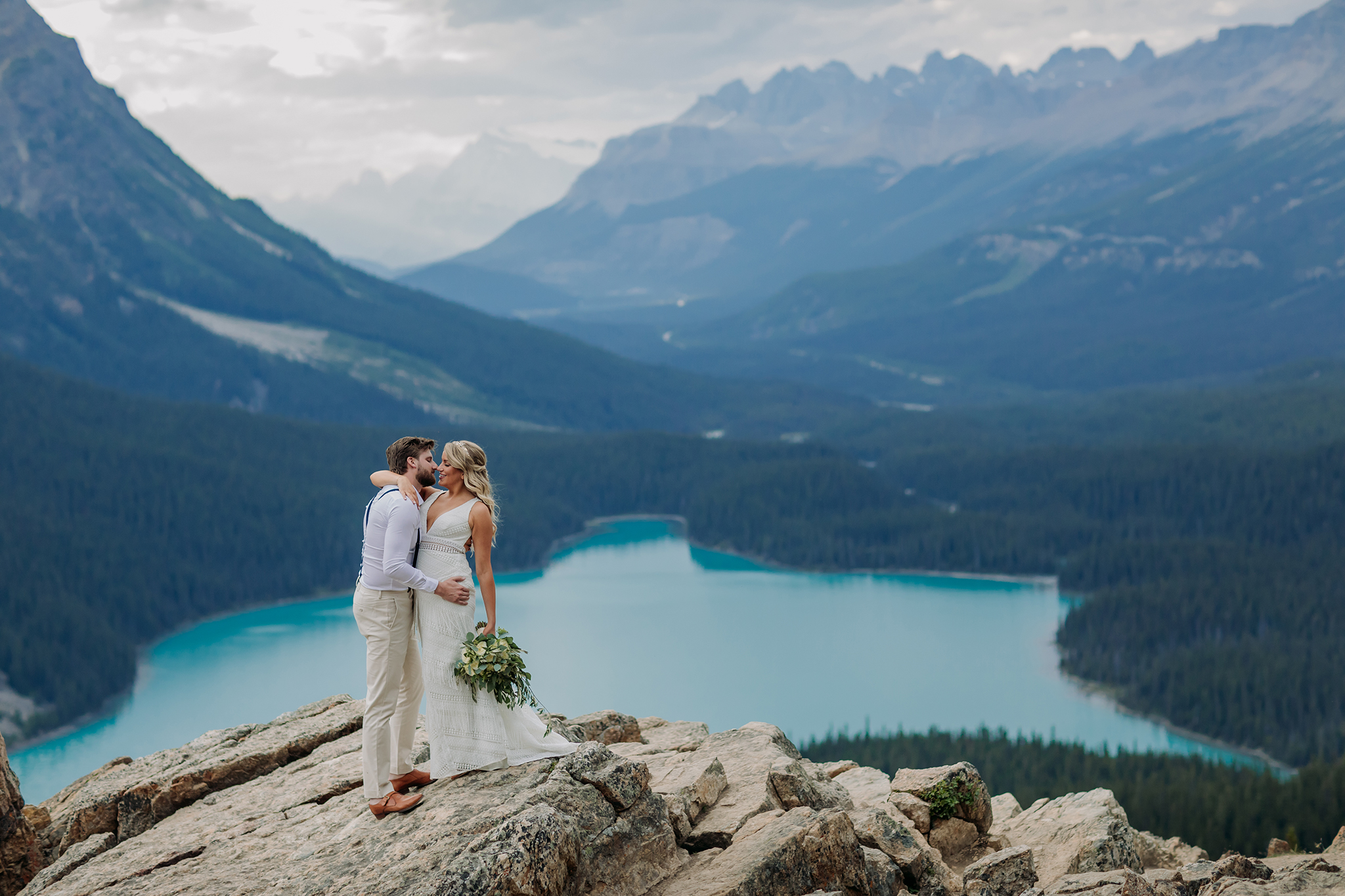 A Guide to Eloping in the Canadian Rockies | Mountain Wedding photographed by ENV Photography | boho mountain wedding at Peyto Lake high on the rocks overlooking incredible mountain views & blue glacial lake