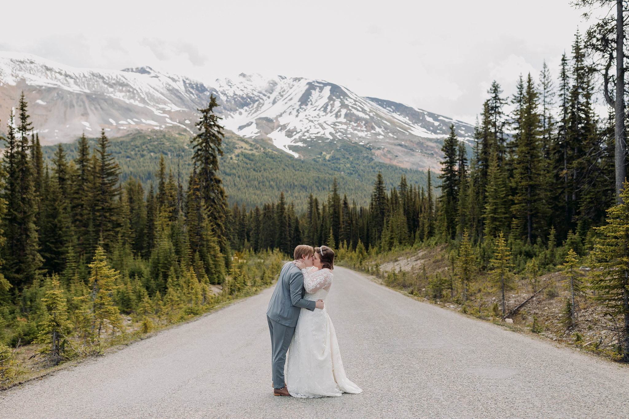 Icefields Parkway adventure session on road to Peyto Lake with same-sex wedding couple days after their wedding. Mountain Wedding portraits photographed by ENV Photography. Gay friendly. LGBTQ friendly wedding & elopement photographer.