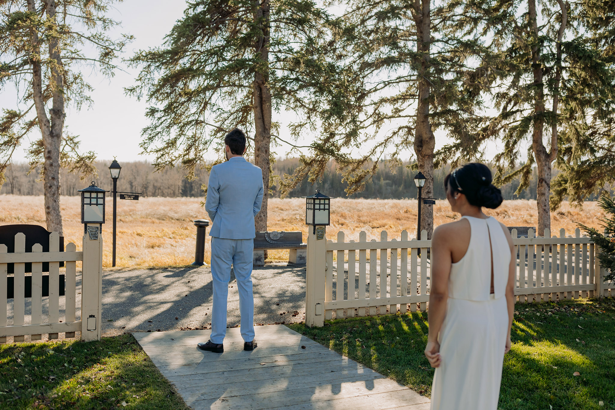 bride & groom have first look on the grounds of Bow Valley Ranche on a sunny October day